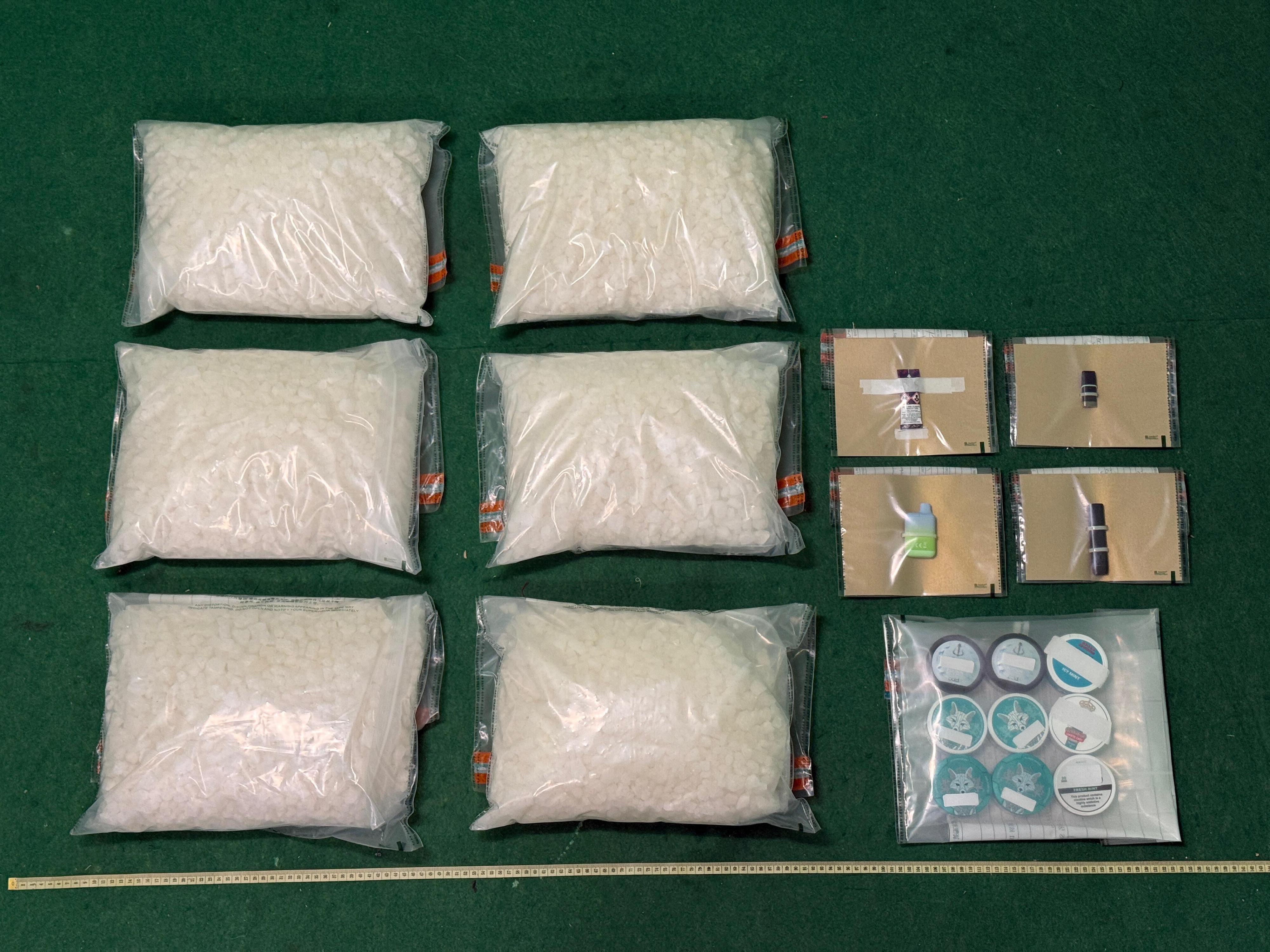 Hong Kong Customs yesterday (August 6) seized about 30 kilograms of suspected ketamine, nine nicotine pouches containing suspected Part I poison nicotine and four suspected alternative smoking products with a total estimated market value of about $12 million. Photo shows the suspected ketamine, nicotine pouches containing suspected Part I poison nicotine and suspected alternative smoking products seized.