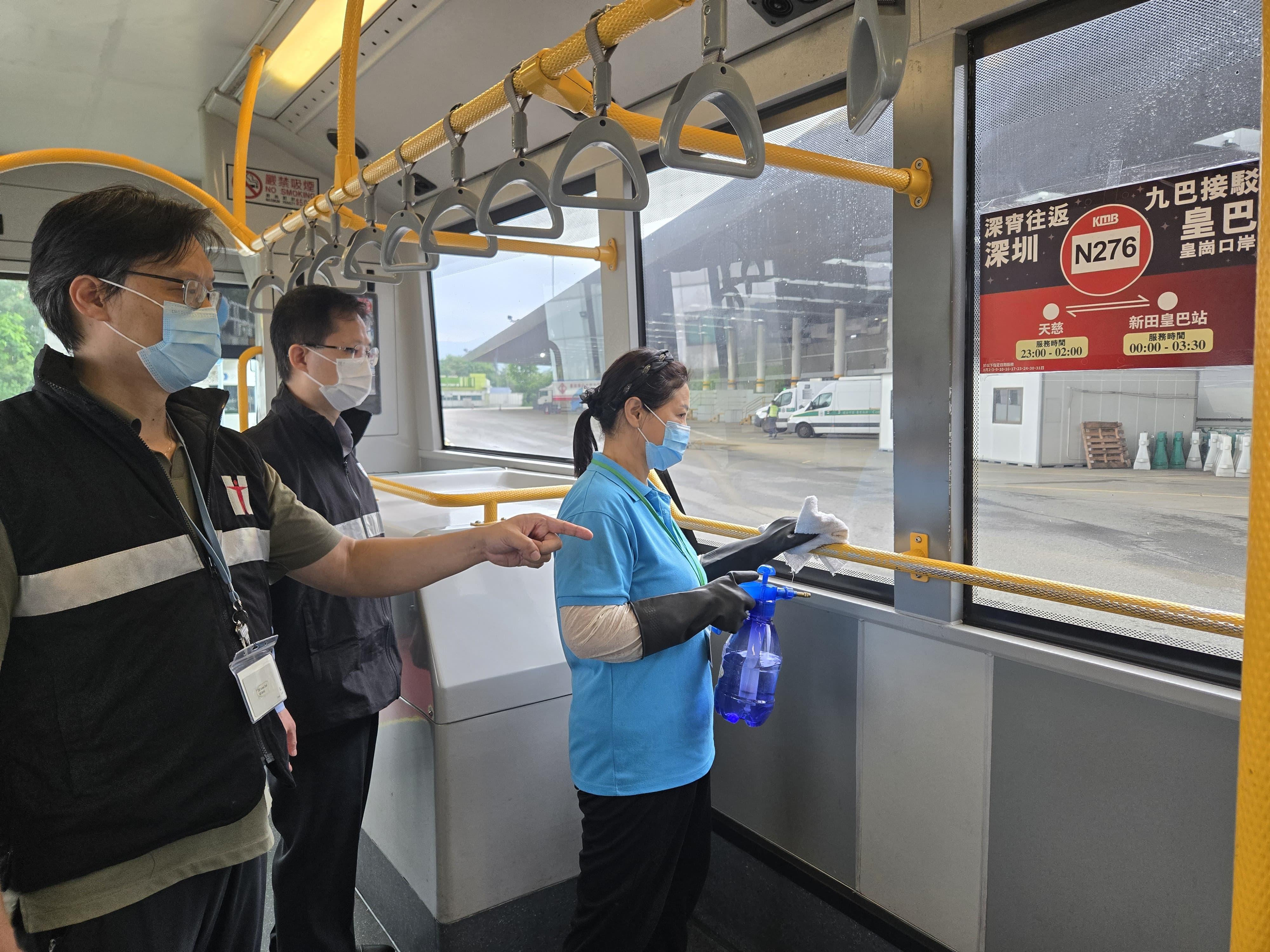 The Centre for Health Protection's Port Health Division continues to step up inspections at boundary control points to ensure good environmental hygiene and effective implementation of anti-mosquito measures. Port Health Division staff members yesterday (August 6) conducted an inspection at the Lok Ma Chau Control Point and the cross-boundary coach terminal. Photo shows Port Health Division staff members giving advice to contractor staff of a cross-boundary coach company on stepping up cleaning work to prevent the breeding of mosquitoes. 