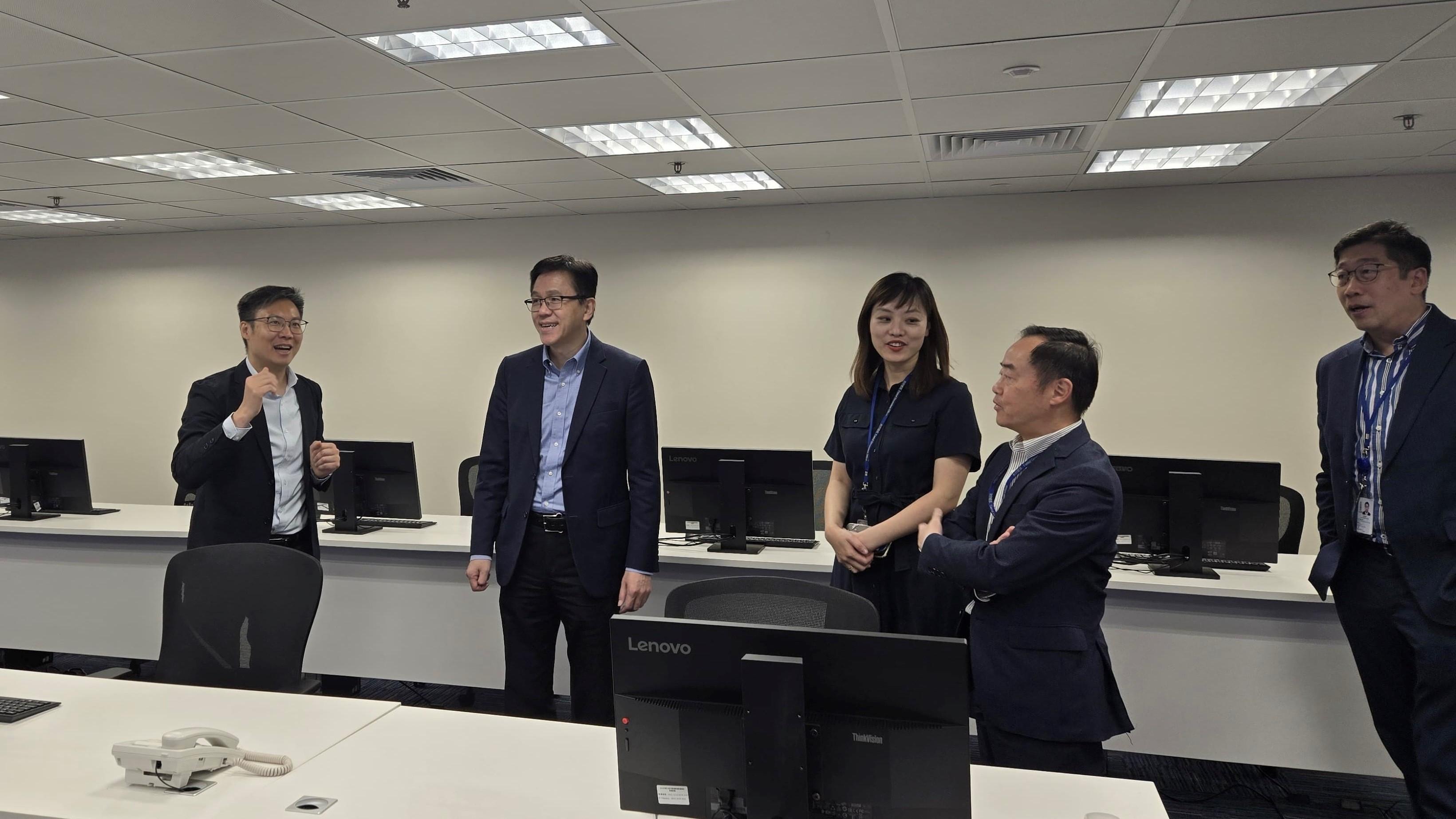 The Secretary for Innovation, Technology and Industry, Professor Sun Dong (second left); the Under Secretary for Innovation, Technology and Industry, Ms Lillian Cheong (third left); the Commissioner for Digital Policy, Mr Tony Wong (second right); and the Deputy Commissioner for Digital Policy (Digital Infrastructure), Mr Daniel Cheung (first right), held a working meeting yesterday (August 11) to review the latest work progress of IT infrastructure of the Digital Policy Office for the 15th National Games, the 12th National Games for Persons with Disabilities and the 9th National Special Olympic Games.
