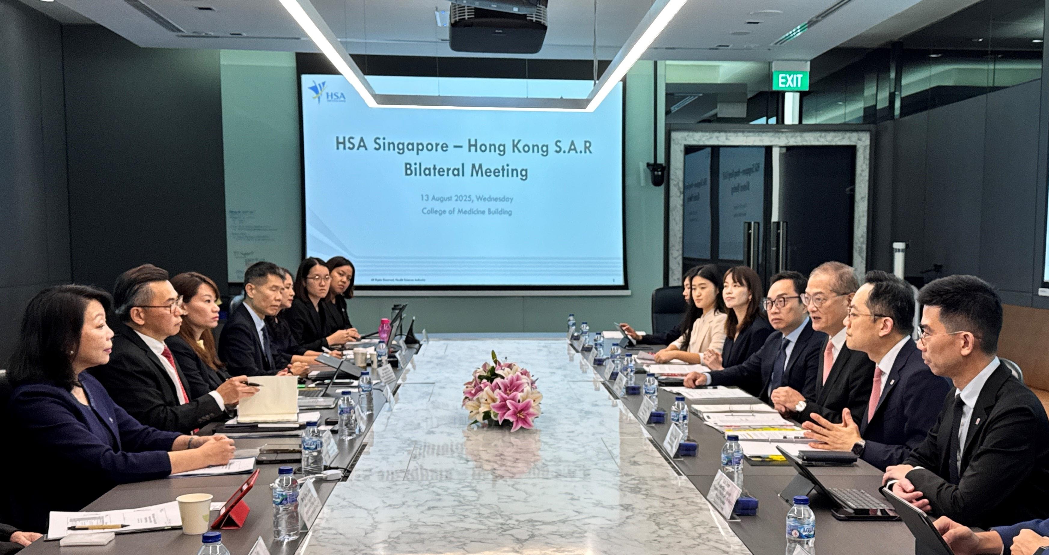 The Secretary for Health, Professor Lo Chung-mau (third right), and his delegation meet with the Chief Executive Officer of the Health Sciences Authority of Singapore, Professor Raymond Chua (second left), in Singapore today (August 13). The Director of Health, Dr Ronald Lam (second right), and Deputy Secretary for Health Ms Elaine Mak (fifth right) also attend the meeting.