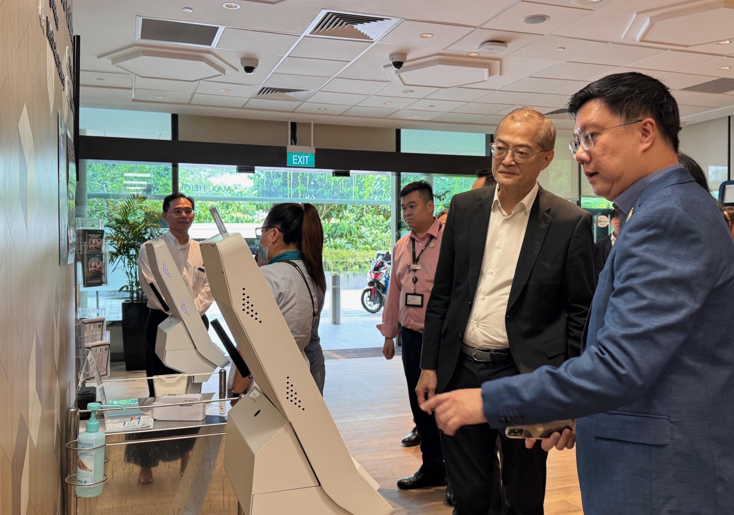 The Secretary for Health, Professor Lo Chung-mau (second right), visits the National Healthcare Group Sembawang Polyclinic in Singapore today (August 14).