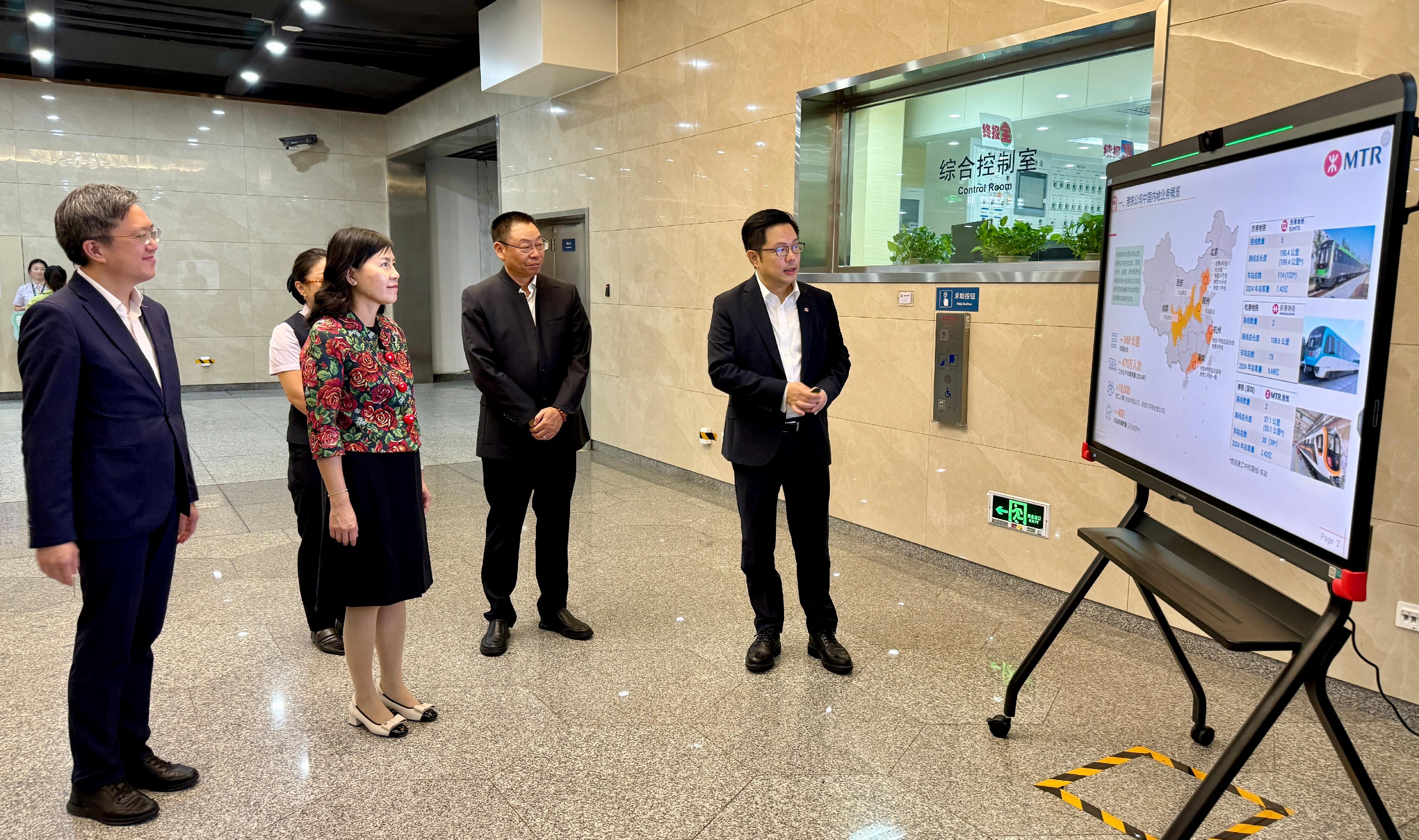 The Secretary for Transport and Logistics, Ms Mable Chan, continued her visit to Beijing today (August 19). Photo shows Ms Chan (second left) being briefed by the Mainland China Business Director of the MTR Corporation Limited, Mr Sammy Wong (first right), on the latest situation of the corporation's business on the Mainland. Looking on is the Permanent Secretary for Transport and Logistics, Mr Kevin Choi (first left).