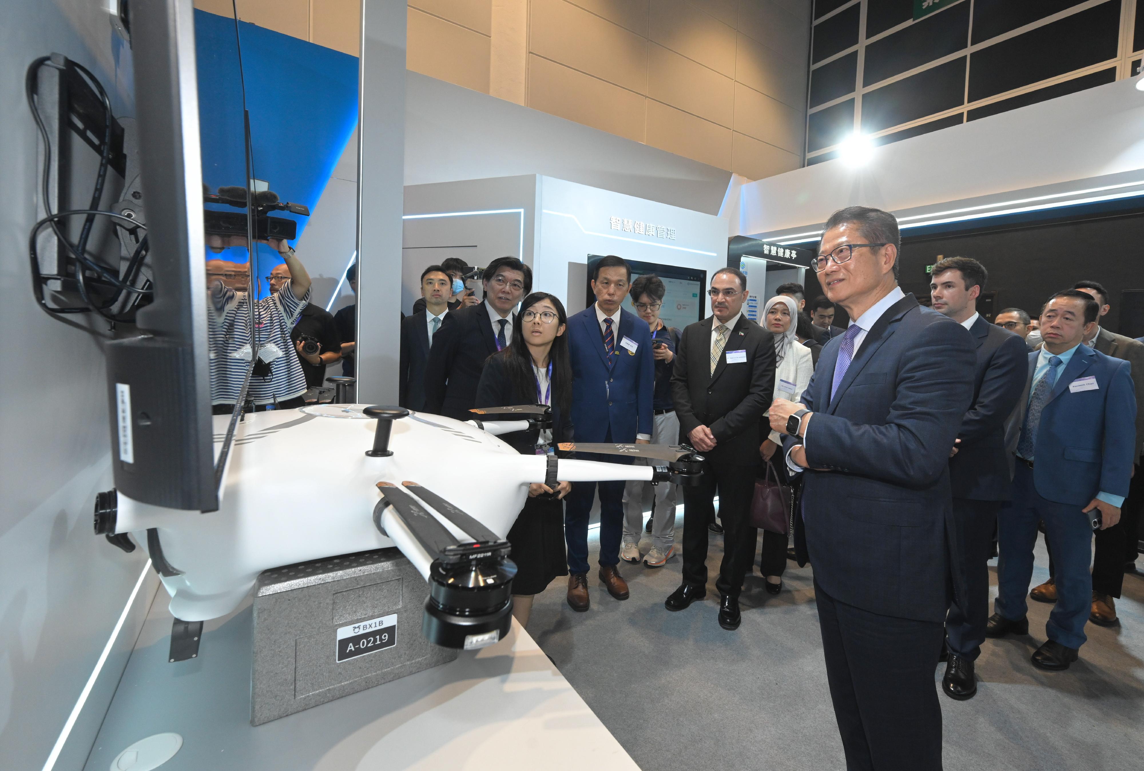 The Financial Secretary, Mr Paul Chan, attended the Opening Ceremony of the Belt and Road Software Pavilion (Hong Kong) 2025 today (August 21). Photo shows Mr Chan (front) touring the Pavillion.