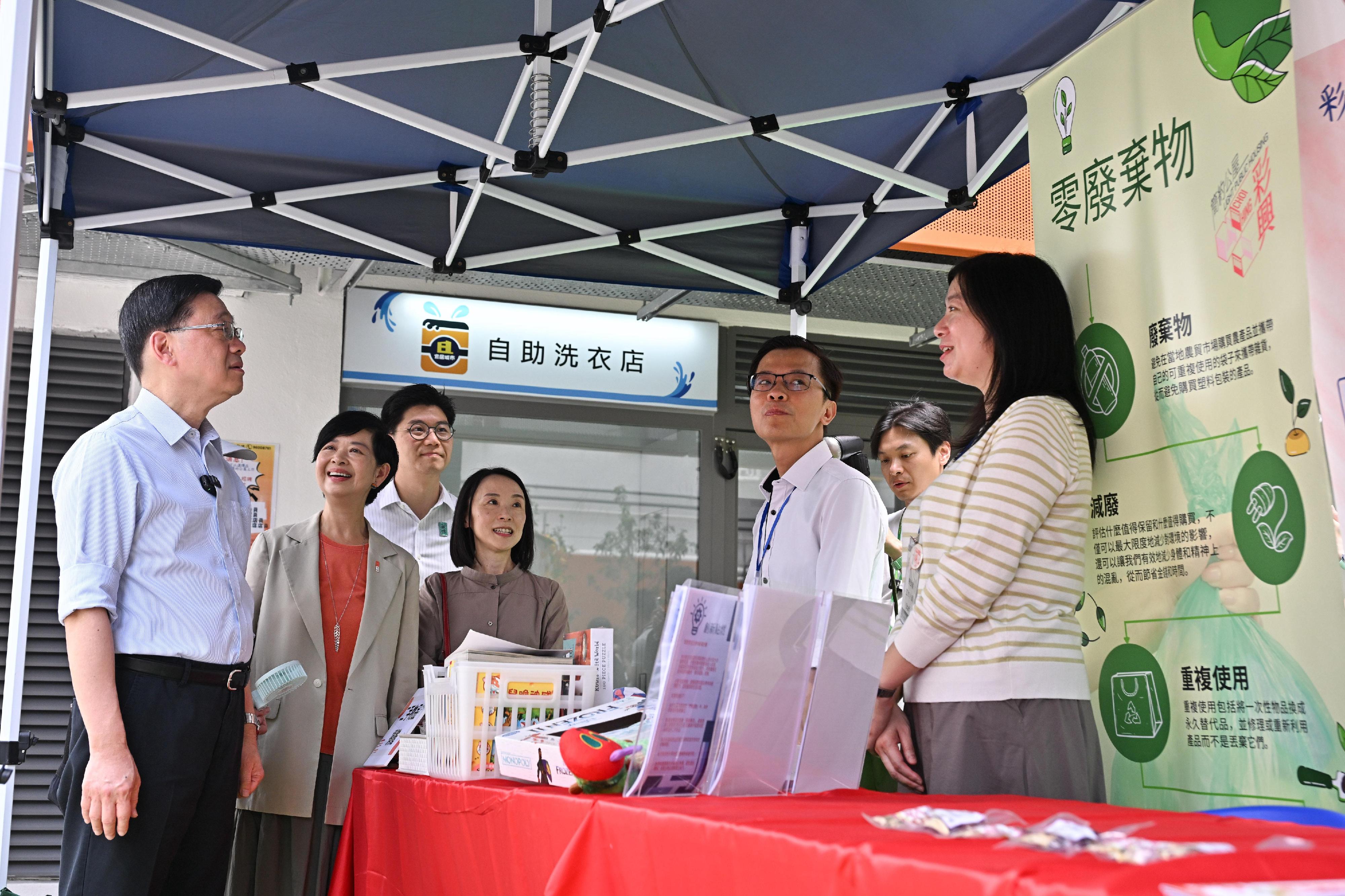 行政長官李家超今日（八月二十三日）到訪觀塘區，就新一份《施政報告》聽取市民意見。圖示李家超（左一）在房屋局局長何永賢（左二）陪同下參觀「簡約公屋」周末市集攤位，並與市民交流。

