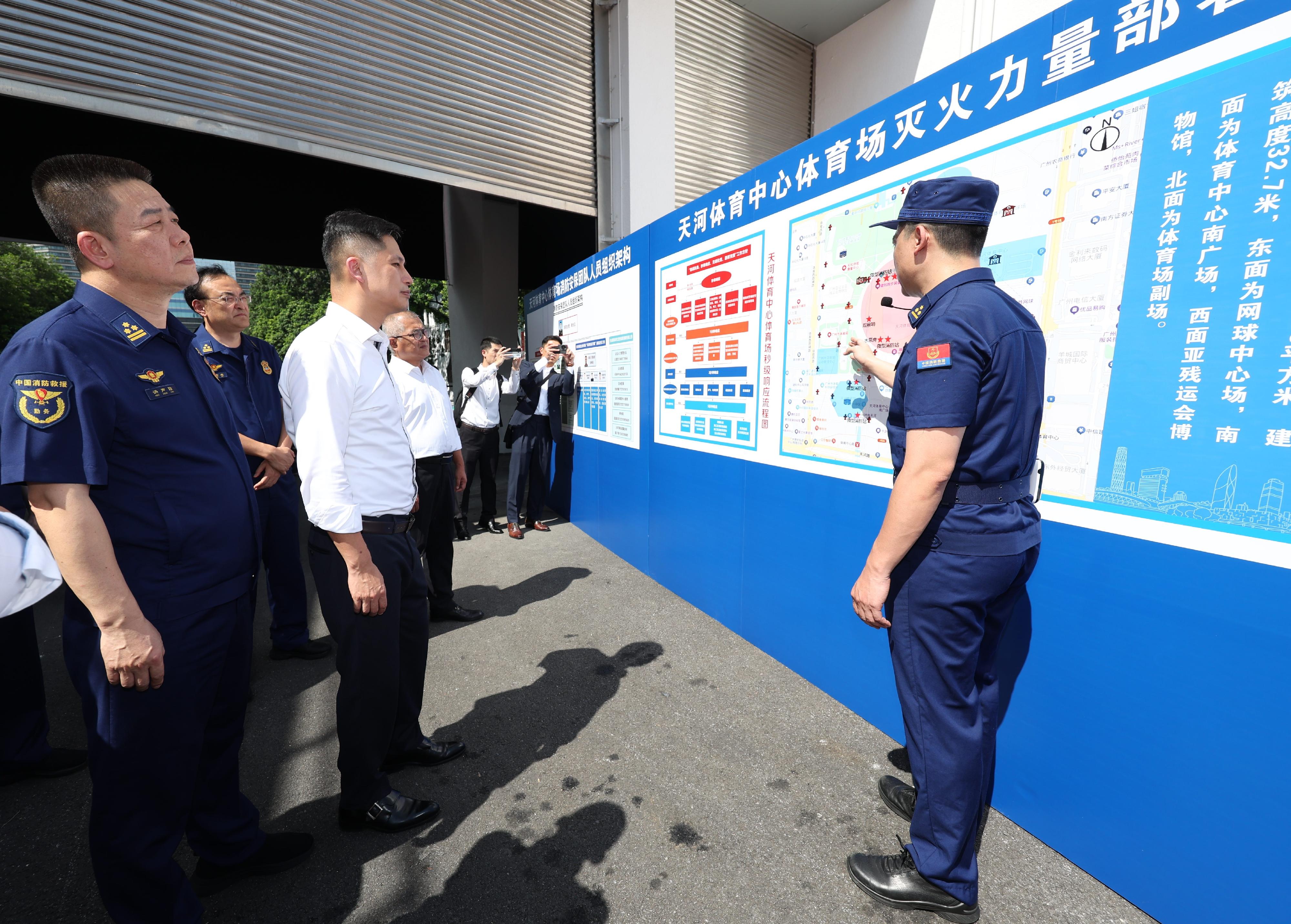 The Director of Fire Services, Mr Andy Yeung, led a delegation to Guangzhou today (August 26) to convene a Guangdong, Hong Kong and Macao fire services security meeting for the 15th National Games with representatives from the Fire and Rescue Corps of Guangdong Province and the Macao Fire Services Bureau. Photo show Mr Yeung (front row, second left) listening to a member of the Fire and Rescue Corps of Guangdong Province explain the fire service installations at the Tianhe Sports Center.