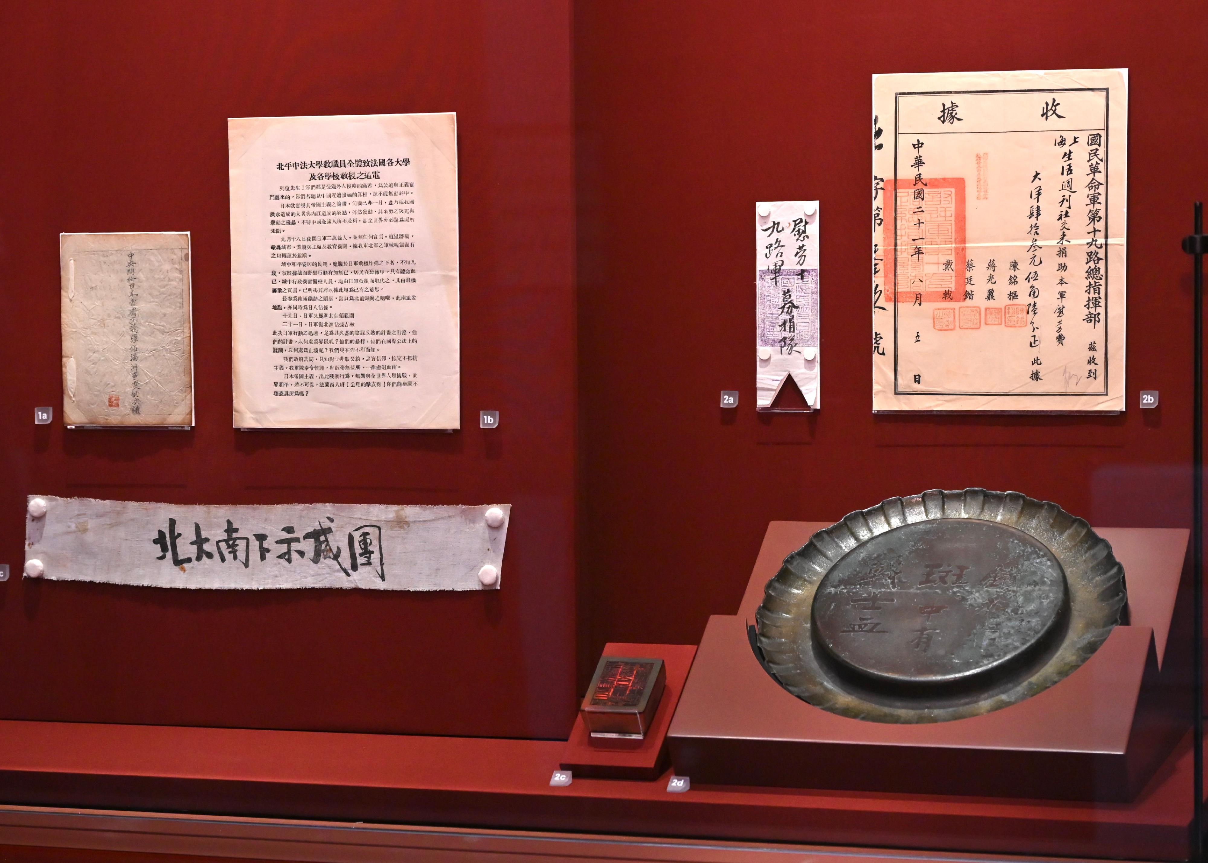 "The Hong Kong Jockey Club Series: United in Arms, Standing for Peace – 80th Anniversary of Chinese Victory in the War of Resistance Exhibition" will be staged at the Hong Kong Museum of History from tomorrow (August 27) until December 15. Photo shows a grade one national treasure, an armband of the Southbound Protest Group from Peking University which marched south to Nanjing shown at bottom row, first left, and an iron plate from patriot Huang Yanpei with the commemorative inscription "Tiehua he banban, zhong you zhan shi xue" (The iron is stained with the blood of soldiers), created after the January 28th Incident in Shanghai seen here in bottom row, first right.