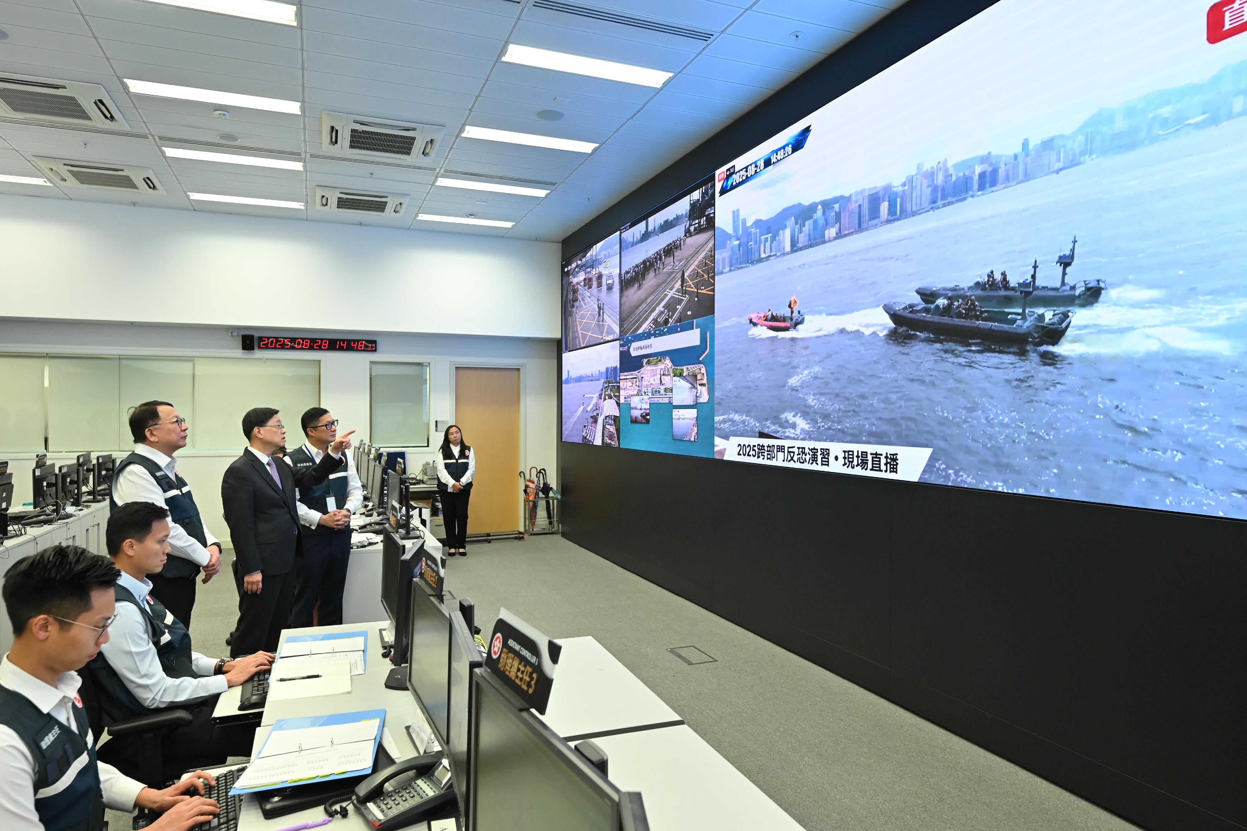 The Inter-departmental Counter Terrorism Unit conducted a large-scale interdepartmental counter-terrorism exercise codenamed BRAVELIGHT at the Kai Tak Cruise Terminal today (August 28). Photo shows the Chief Executive, Mr John Lee (third right); the Chief Secretary for Administration, Mr Chan Kwok-ki (third left); and the Secretary for Security, Mr Tang Ping-keung (second right); overseeing the exercise at the Emergency Monitoring and Support Centre.