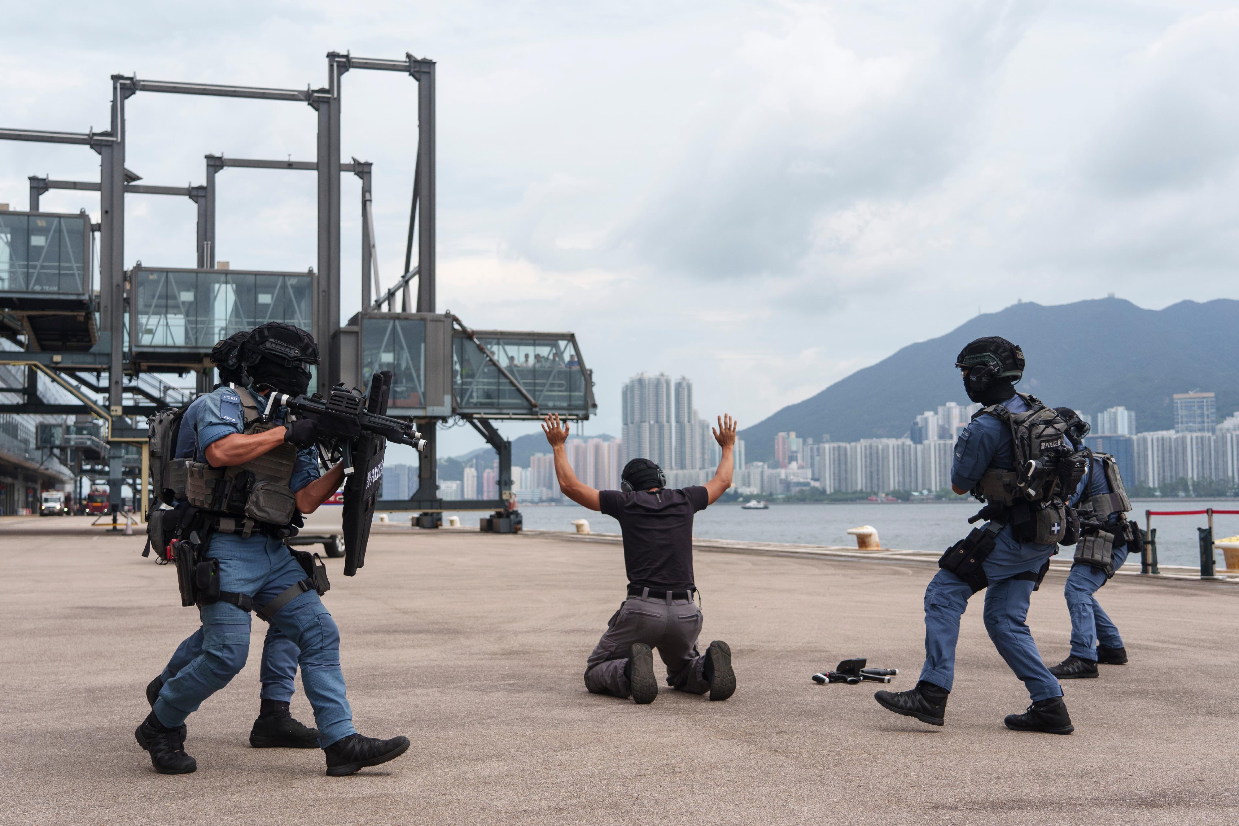 The Inter-departmental Counter Terrorism Unit conducted a large-scale interdepartmental counter-terrorism exercise codenamed BRAVELIGHT at the Kai Tak Cruise Terminal today (August 28). Photo shows officers of the Police Counter Terrorism Response Unit subduing a terrorist.