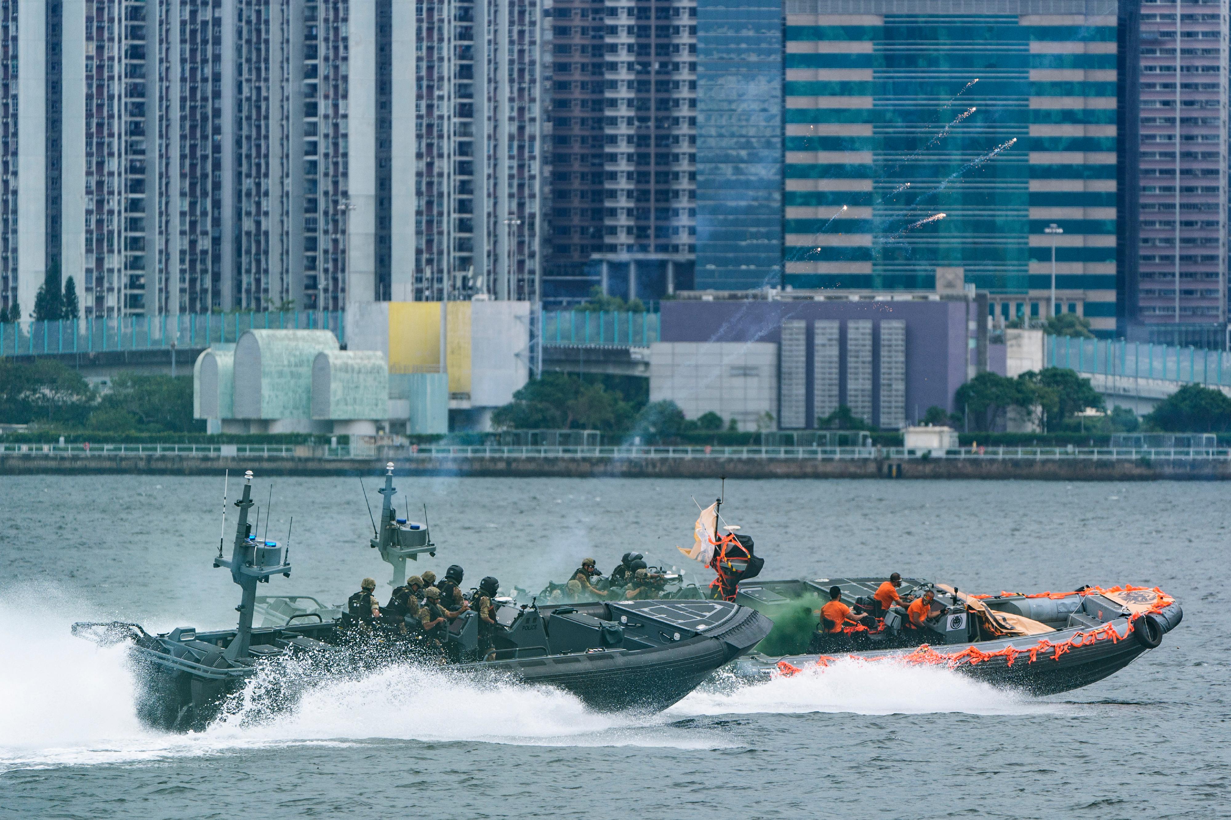 The Inter-departmental Counter Terrorism Unit conducted a large-scale interdepartmental counter-terrorism exercise codenamed BRAVELIGHT at the Kai Tak Cruise Terminal today (August 28). Photo shows officers of the Police Small Boat Unit pursuing a suspicious speedboat with High Speed Interceptor.