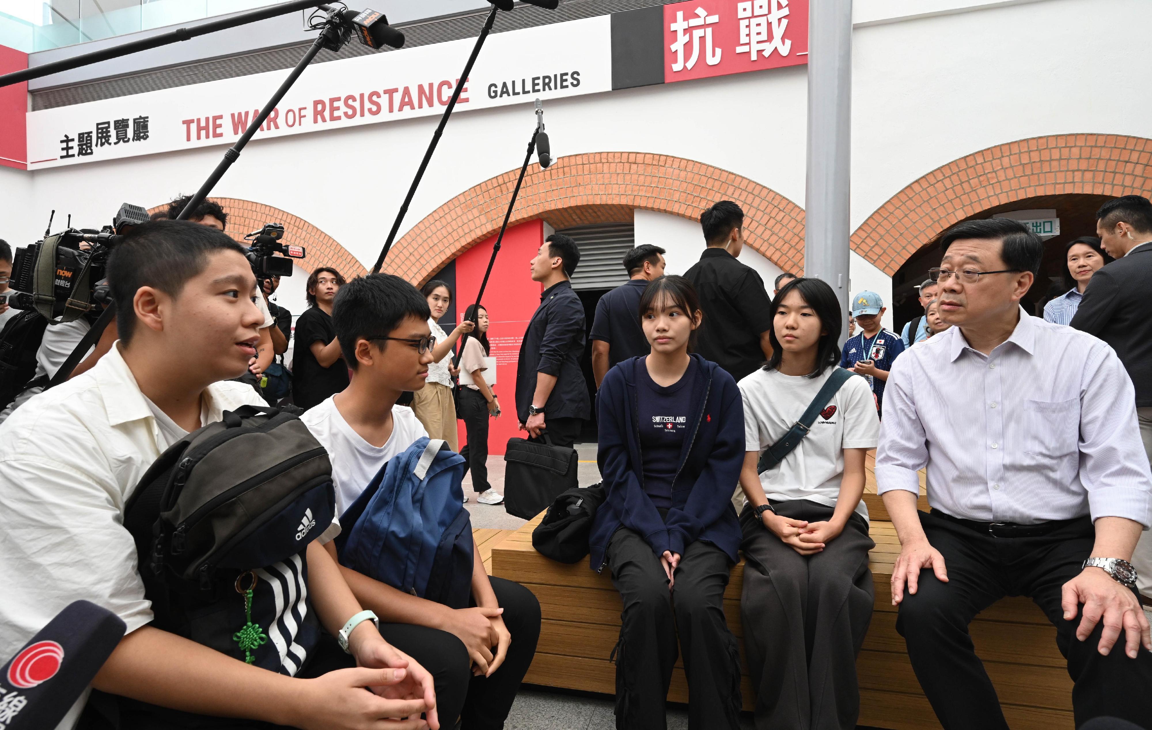 The Chief Executive, Mr John Lee, visited Eastern District today (August 30) to gather public views on the upcoming Policy Address. Photo shows Mr Lee (first right) visiting the Hong Kong Museum of the War of Resistance and Coastal Defence and interacting with members of the public on-site.