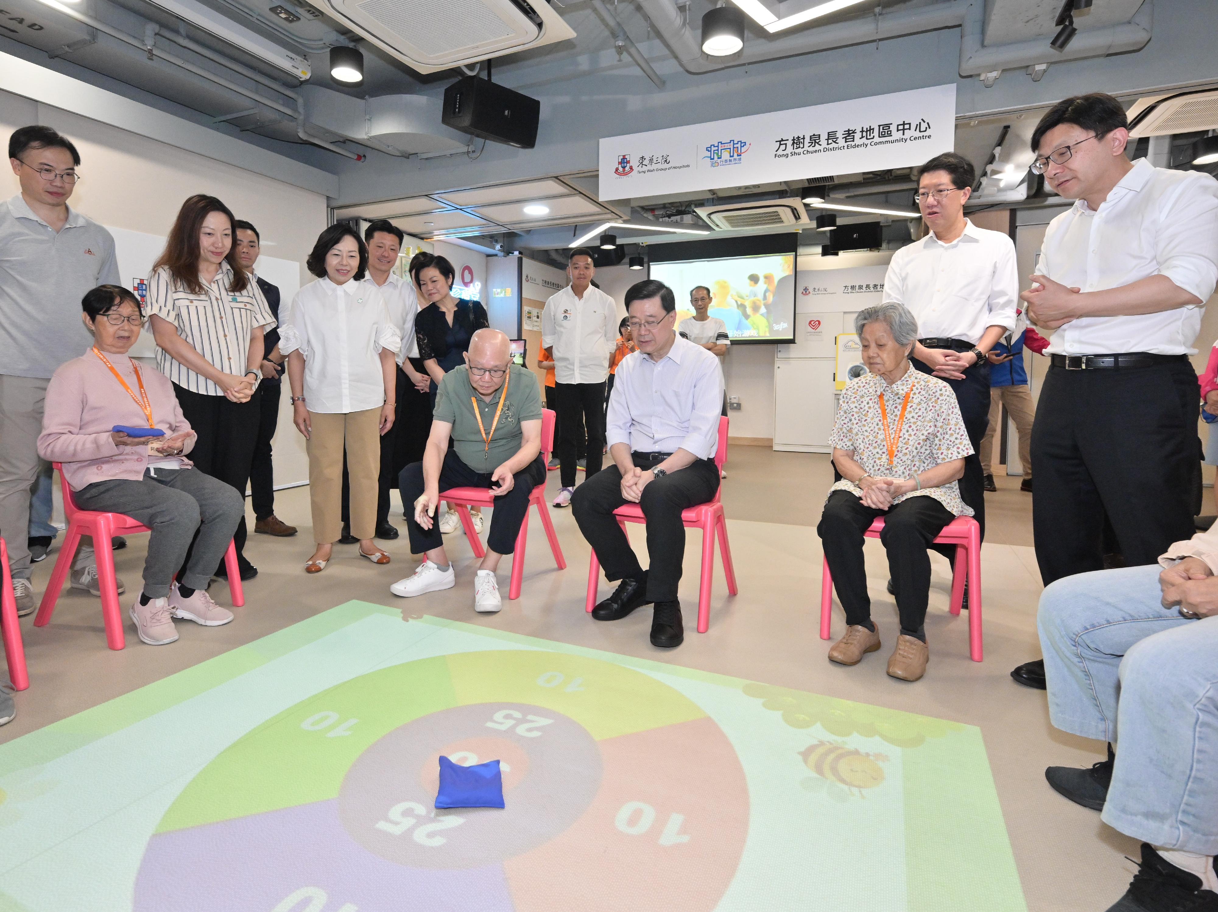 The Chief Executive, Mr John Lee, visited Eastern District today (August 30) to gather public views on the upcoming Policy Address. Photo shows Mr Lee (fourth right) accompanied by the Secretary for Home and Youth Affairs, Miss Alice Mak (fourth left), and the Secretary for Labour and Welfare, Mr Chris Sun (first right), visiting a social service building and interacting with the centre users.