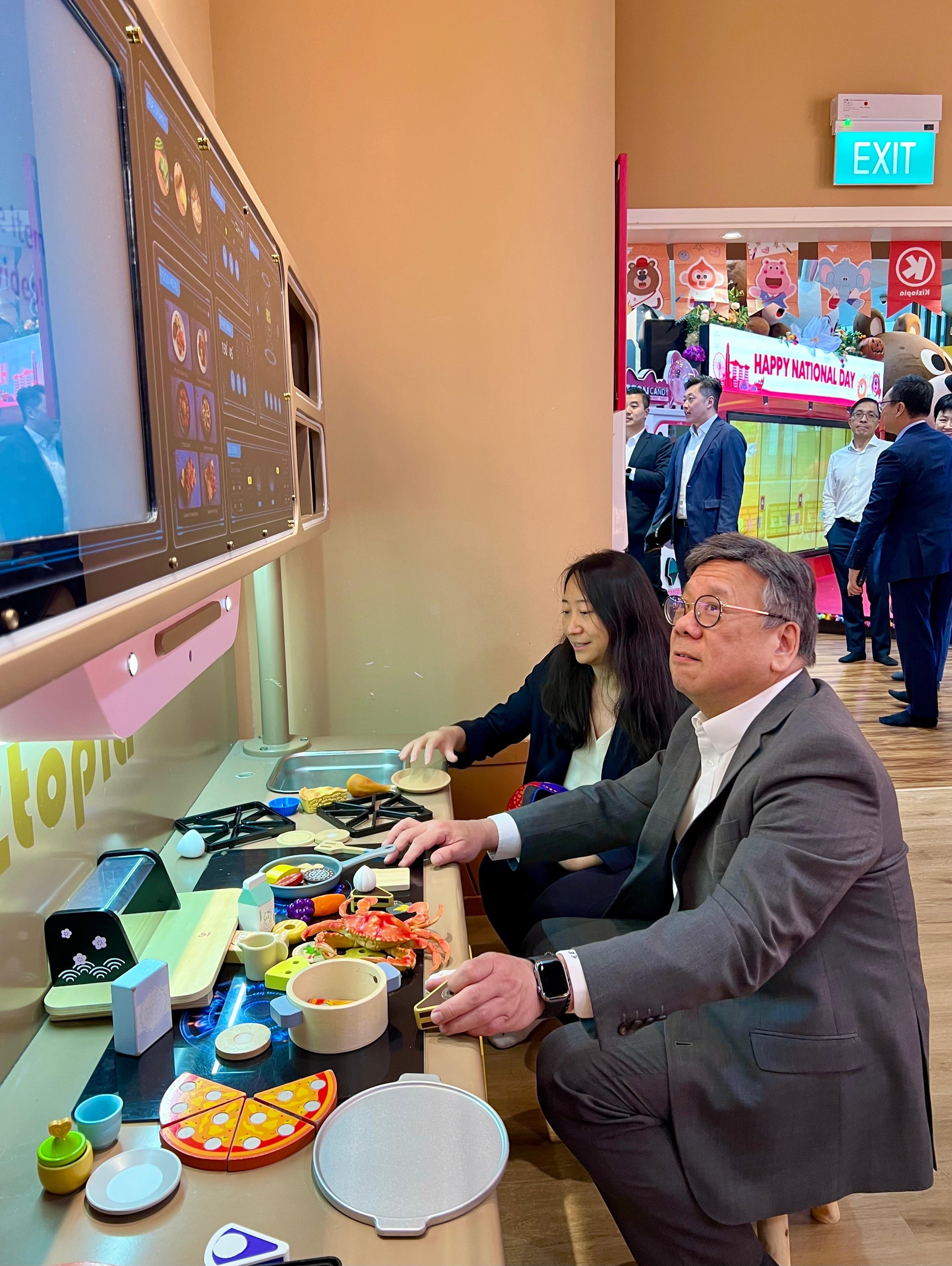 The Secretary for Commerce and Economic Development, Mr Algernon Yau, today (September 1) visited Singapore to have exchanges with the political and business sectors to forge an even closer relationship between Hong Kong and Singapore, leveraging the complementary advantages of the two places. Photo shows Mr Yau (right) visiting a family edutainment company that has outlets in Hong Kong, and experiencing first-hand its activities in the company of its senior management.