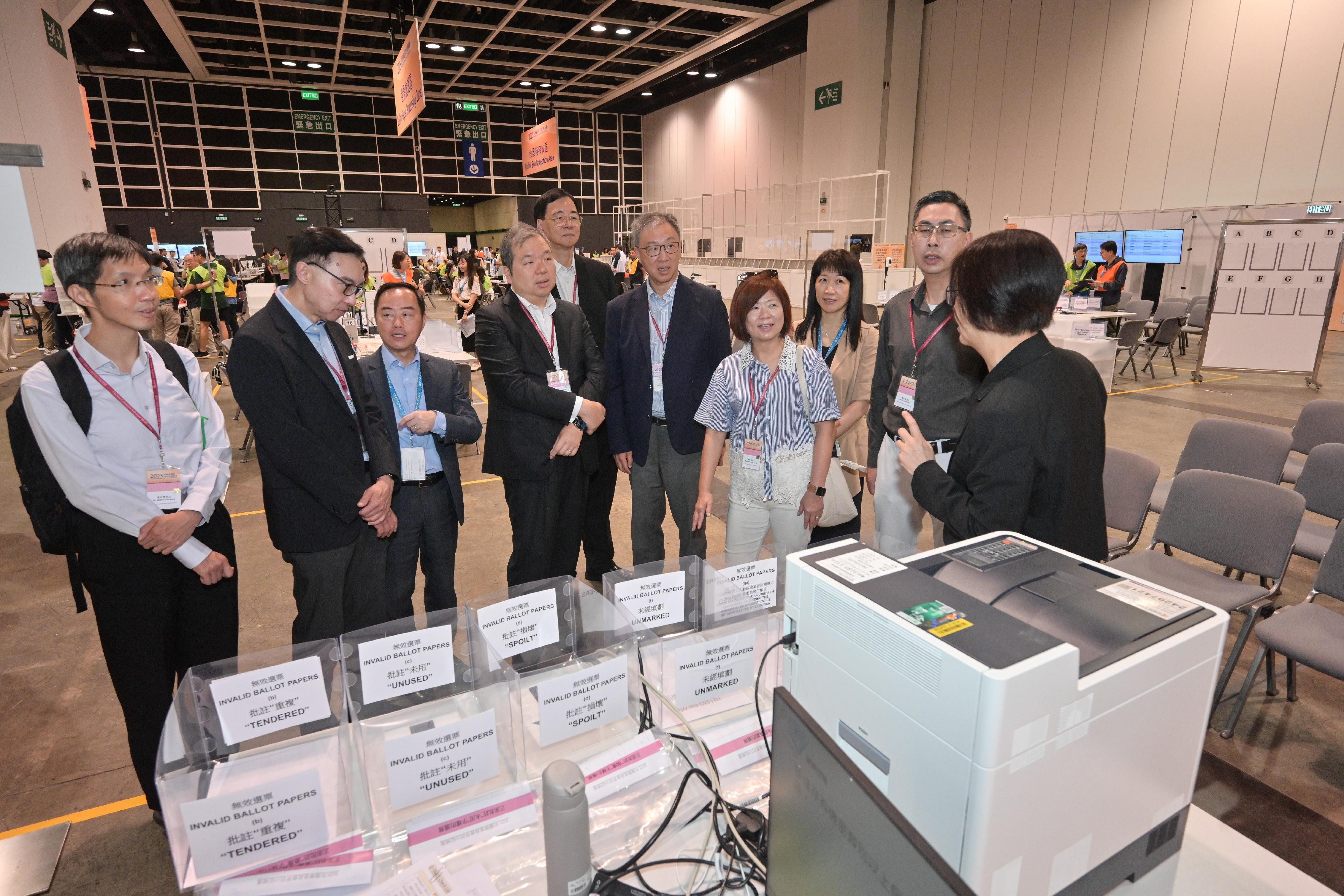 The Chairman of the Electoral Affairs Commission (EAC), Mr Justice David Lok (fourth right); EAC members Professor Daniel Shek (fifth left) and Mr Bernard Man, SC (fourth left), today (September 6) visit the Central Counting Station of the 2025 Election Committee Subsector By-elections at the Hong Kong Convention and Exhibition Centre to inspect the on-site drill conducted by staff members to ensure a smooth operation of the counting work. They are accompanied by the Commissioner for Digital Policy, Mr Tony Wong (third left); the Convenor of the Technical Advisory Committee (TAC), Mr Sunny Lee (second left); the Chief Electoral Officer of the Registration and Electoral Office, Ms Natalie Chan (second right), and Members of the TAC.