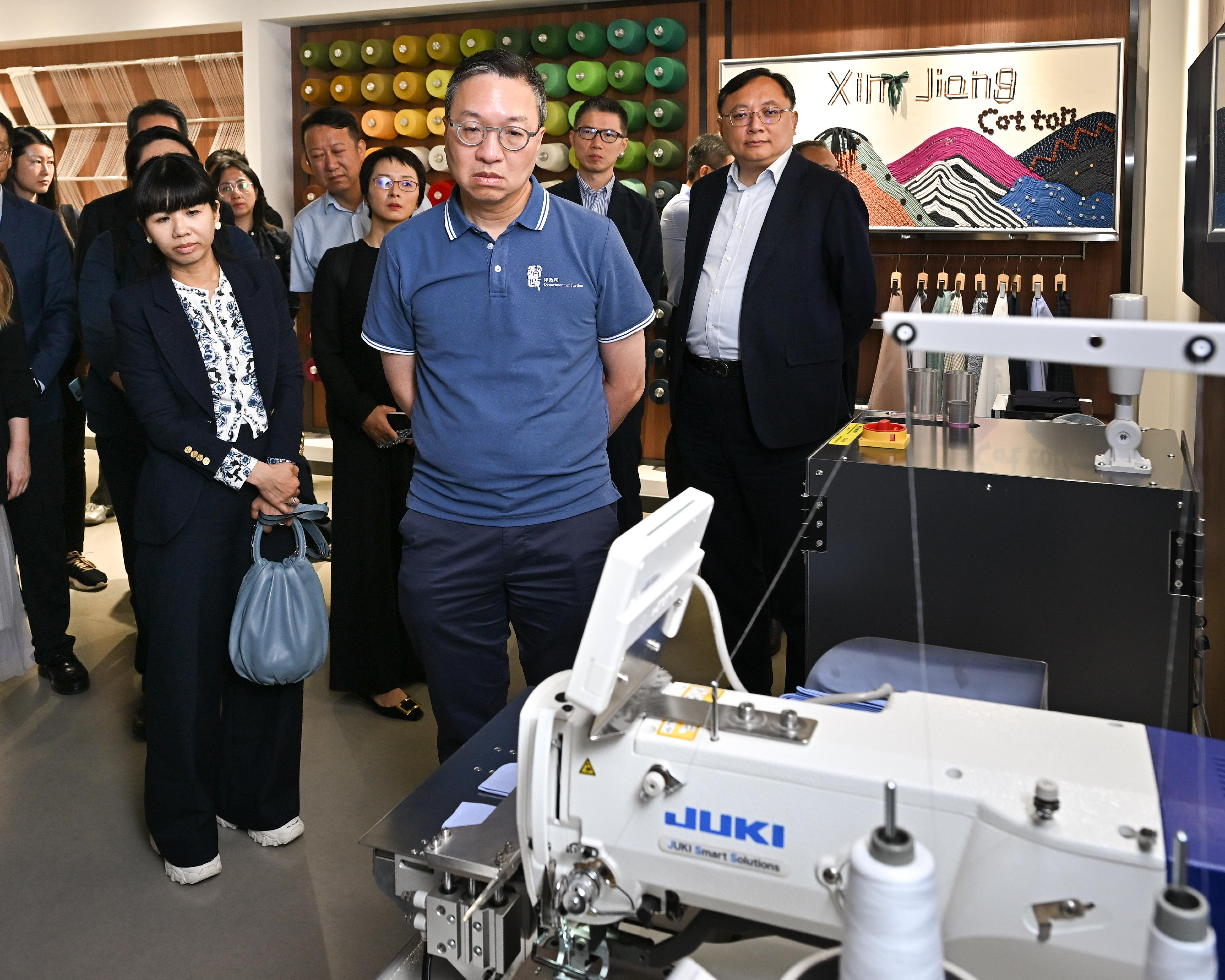 The Secretary for Justice, Mr Paul Lam, SC, leading a cross-professional delegation to visit Urumqi, Xinjiang today (September 13). Photo shows Mr Lam (front row, right) and the delegation visiting a Hong Kong-invested enterprise in Urumqi.