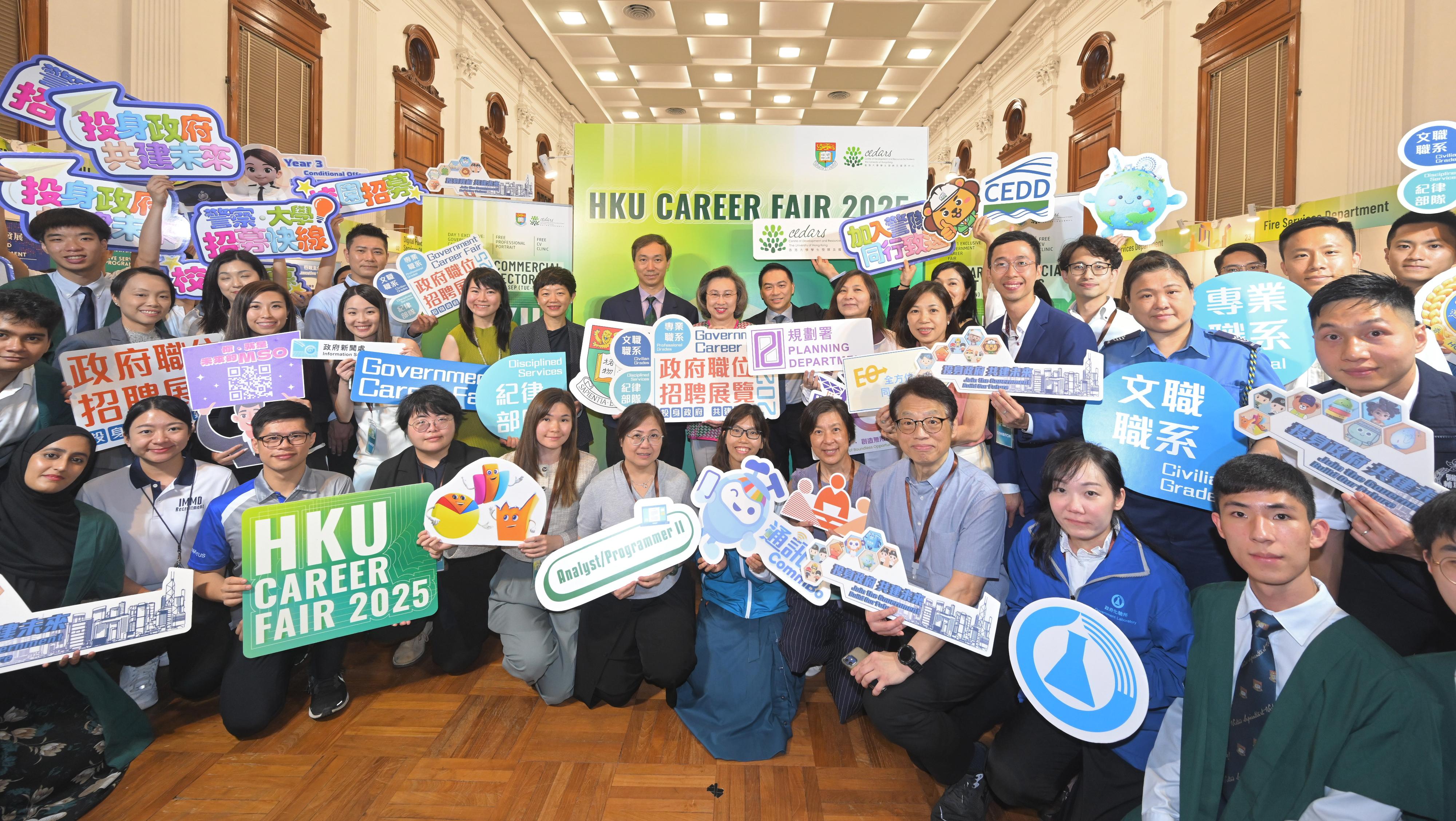 公務員事務局局長楊何蓓茵今日（九月十五日）下午到香港大學出席本年度首個在本地大學舉辦的政府職位招聘展覽。圖示楊何蓓茵（第二排左八）、香港大學副校長（商業策略）林晨教授（第二排左七）和香港大學學生事務長楊偉國教授（第二排左九）與參與展覽的決策局和部門代表和學生合照。