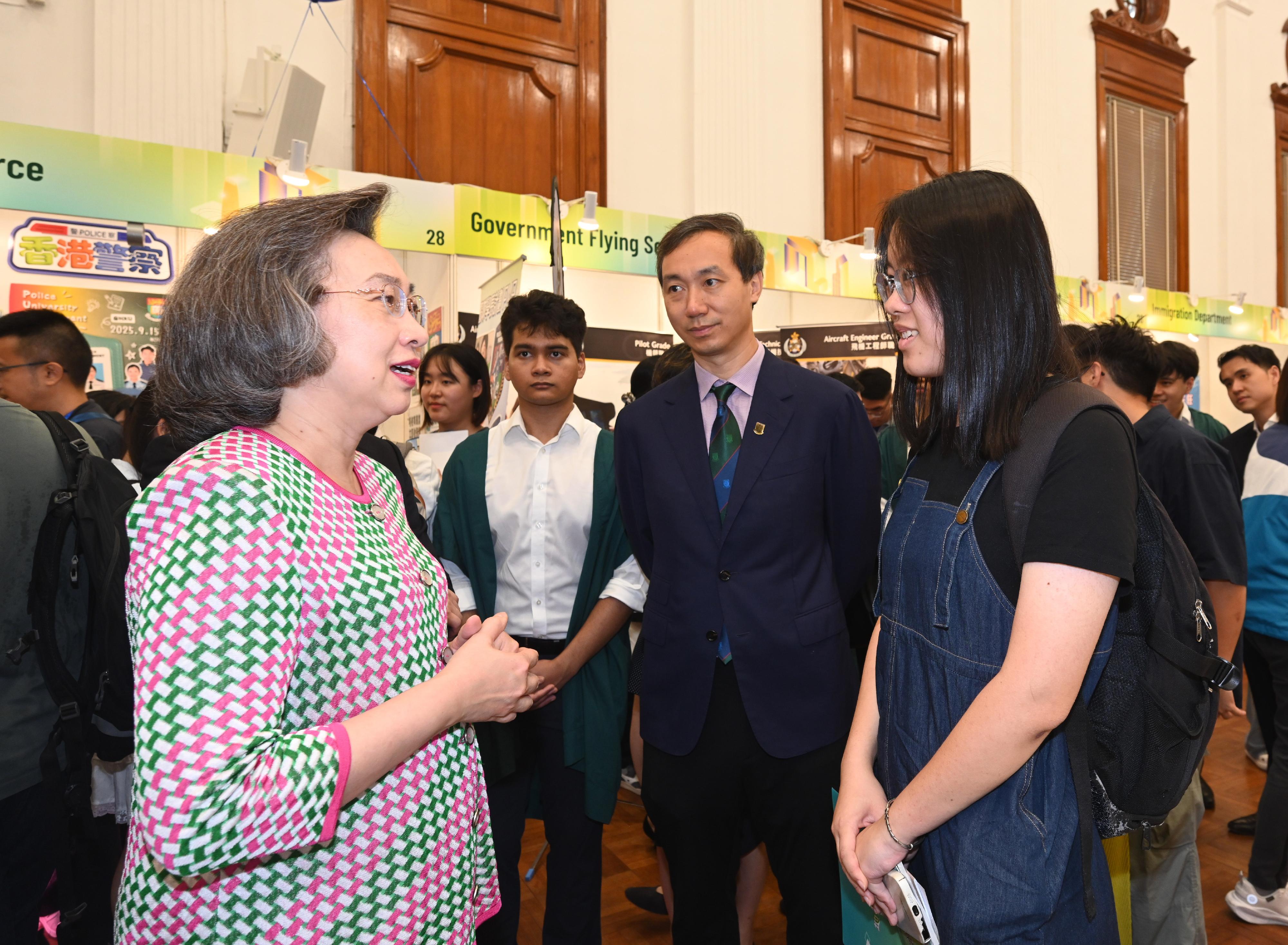 The Secretary for the Civil Service, Mrs Ingrid Yeung, attended the first Government Career Fair being held at local universities this year at the University of Hong Kong (HKU) this afternoon (September 15). Photo shows Mrs Yeung (first left) chatting with a student attending the fair. Looking on is the Vice-President and Pro-Vice-Chancellor (Business) of HKU, Professor Lin Chen (second right).