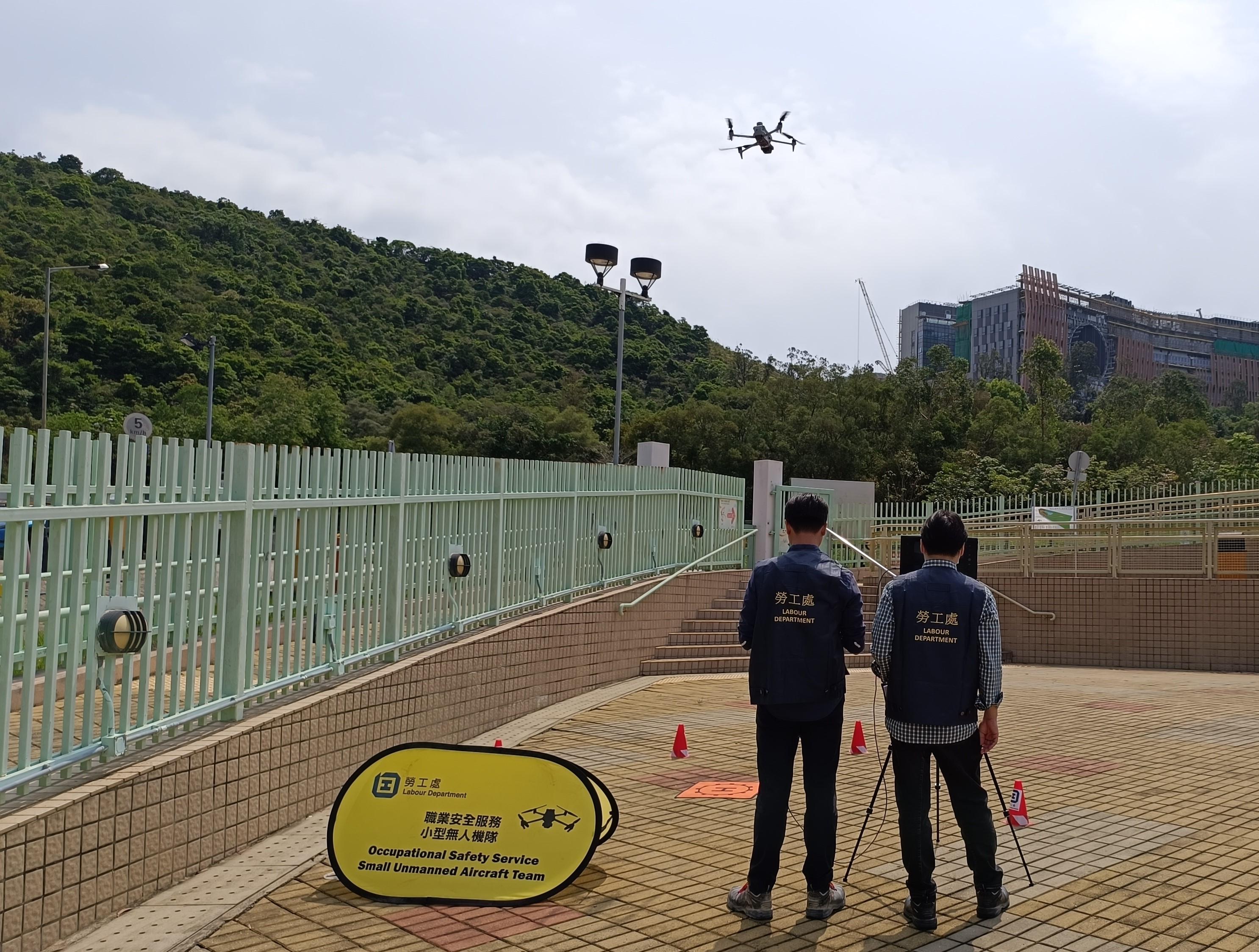 The Labour Department will start using small unmanned aircraft (SUA) from October to assist with inspections and enforcement actions. Photo shows Occupational Safety Officers demonstrating the use of an SUA in a drill. 