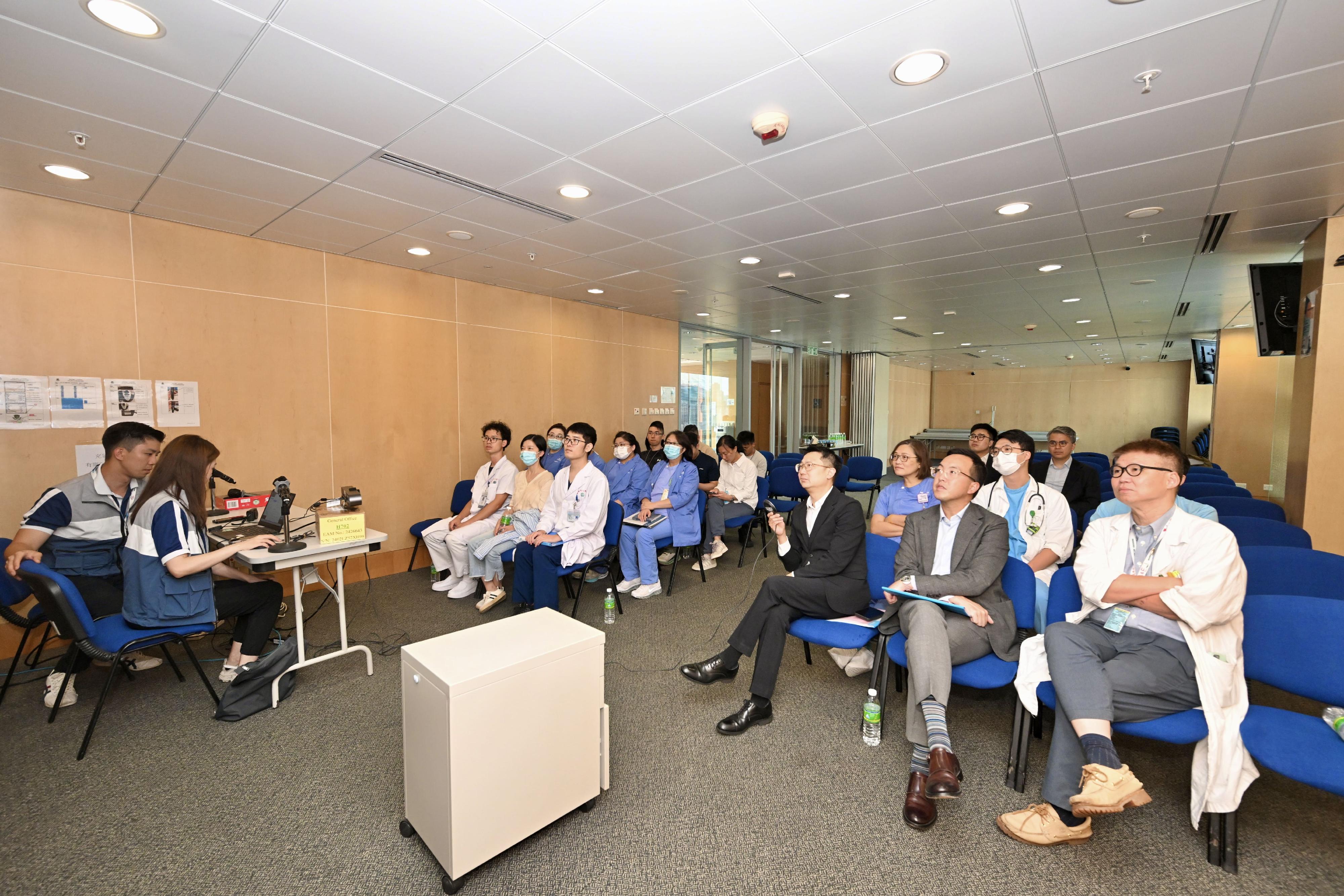 The Hong Kong Special Administrative Region Government, in collaboration with the People's Government of Zhuhai Municipality, conducted a drill for the Pilot Scheme for Direct Cross-boundary Ambulance Transfer in the Greater Bay Area today (September 26). Photo shows Acting Deputy Secretary for Health Mr Gordon Chong (front row, second right), the Senior Advisor (Secretary for Health's Office), Dr Joe Fan (front row, third right), and participating personnel having a preliminary review on the drill today.