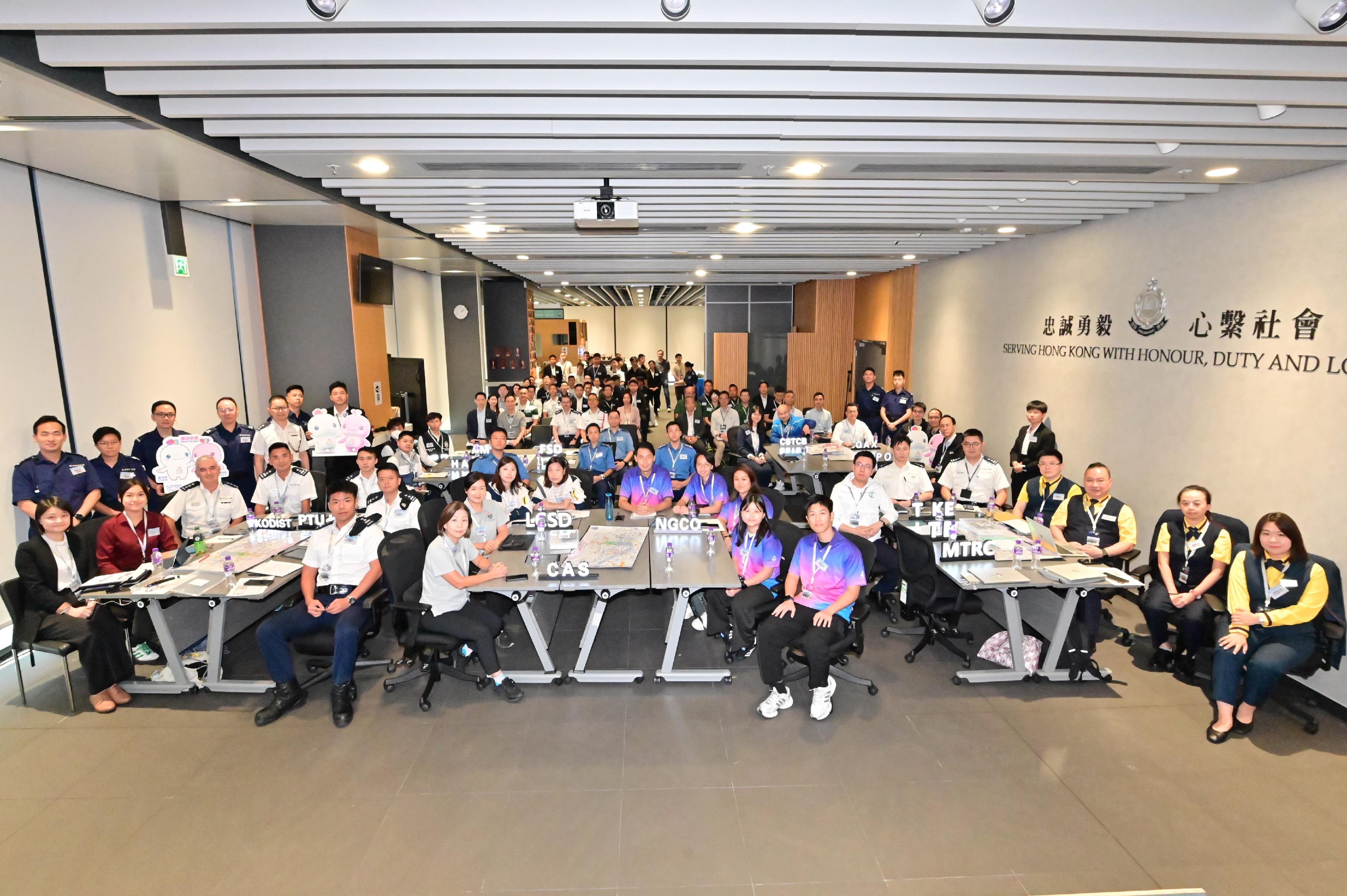 The Kowloon East Region of the Hong Kong Police Force today (September 26) conducted the inter-departmental tabletop exercise for the 15th National Games, the 12th National Games for Persons with Disabilities and the 9th National Special Olympic Games, codenamed "PLACIDSEA II", at the Kowloon East Regional Headquarters. Photo shows the Regional Commander of Kowloon East, Dr Law Yuet-wing (second row, fifth right), with representatives from various government departments and related organisations.