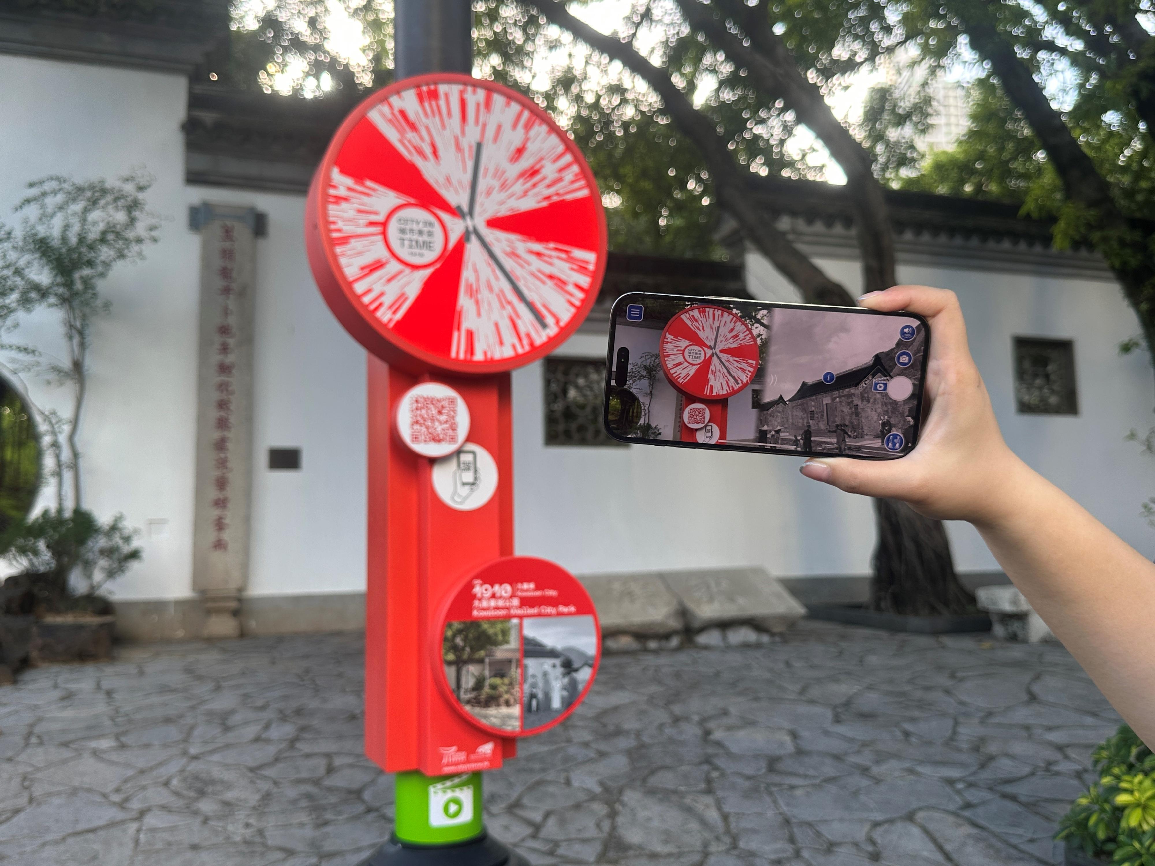 The Tourism Commission today (September 30) launched additional City in Time spots in Kowloon City. Photo shows a visitor using a smart phone to experience the City in Time app inside Kowloon Walled City Park.