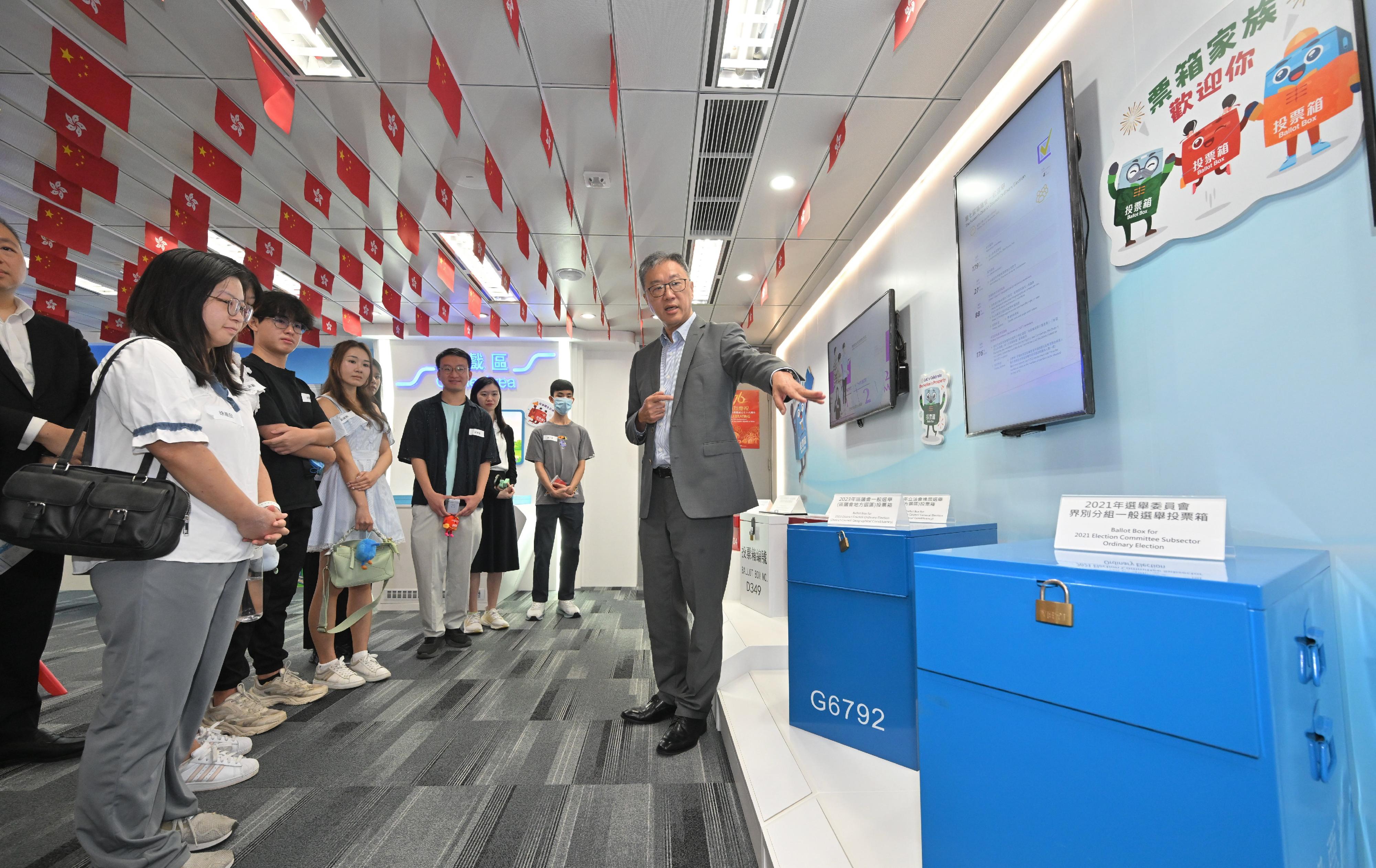 The Chairman of the Electoral Affairs Commission (EAC), Mr Justice David Lok, today (September 30) hosted a youth exchange and guided tour programme at the National Day Open Days of the Electoral Information Centre (EIC) of the Registration and Electoral Office. EAC members Professor Daniel Shek and Mr Bernard Man, SC, also attended today's event. Photo shows Mr Justice Lok (first right) leading a group of around 10 youngsters on a tour around the EIC and introducing them to the ballot boxes used in previous elections.