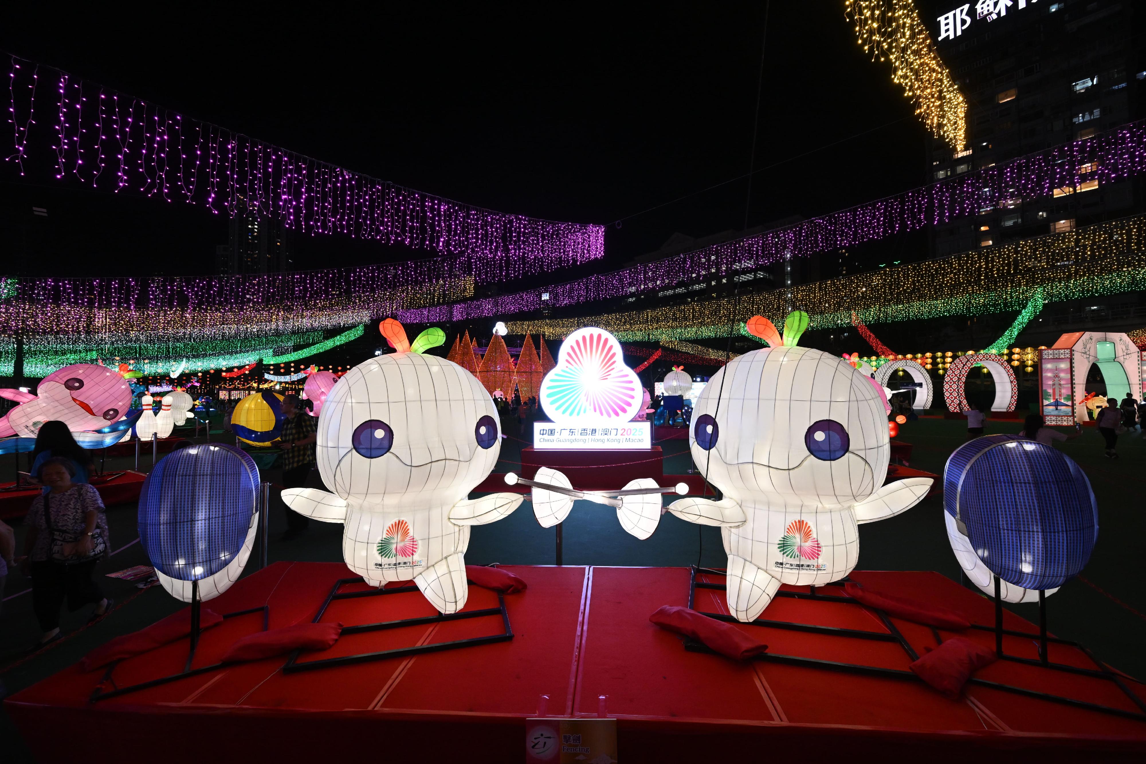 The Mid-Autumn Lantern Carnival 2025, organised by the Leisure and Cultural Services Department, is running from today (September 30) until October 7 at Victoria Park to celebrate National Day and the Mid-Autumn Festival, and welcoming the National Games. Photo shows the lantern display "Gold Shines, Energy Explodes" featuring the mascots of the 15th National Games, the 12th National Games for Persons with Disabilities and the 9th National Special Olympic Games dressed in sportswear representing different competition events to be staged in Hong Kong.