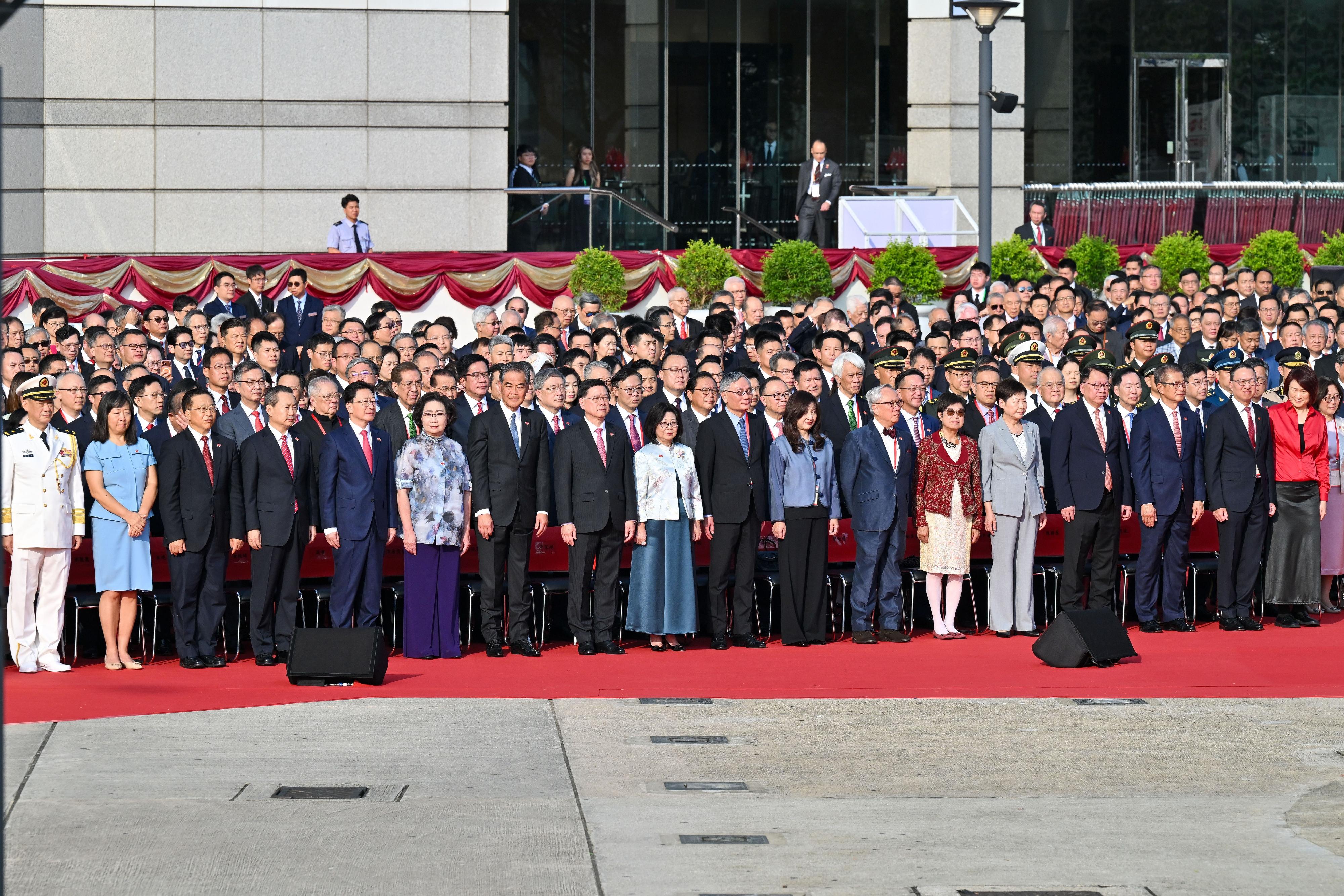 The Chief Executive, Mr John Lee (front row, 8th left), and his wife (front row, 9th left); the Chief Justice of the Court of Final Appeal, Chief Justice Andrew Cheung (front row, 9th right), and his wife (front row, 8th right); former CE Mr Donald Tsang (front row, 7th right), and his wife (front row, 6th right); Vice-Chairman of the National Committee of the CPPCC Mr C Y Leung (front row, 7th left), and his wife (front row, 6th left); former CE Mrs Carrie Lam (front row, 5th right); the Director of the Liaison Office of the Central People's Government (CPG) in the Hong Kong Special Administrative Region (HKSAR), Mr Zhou Ji (front row, 5th left); the Head of the Office for Safeguarding National Security of the CPG in the HKSAR, Mr Dong Jingwei (front row, 4th left); the Commissioner of the Ministry of Foreign Affairs in the HKSAR, Mr Cui Jianchun (front row, 3rd left), and his wife (front row, 2nd left); the Political Commissar of the CPLA Hong Kong Garrison, Navy Rear Admiral Lai Ruxin (front row, 1st left); the Chief Secretary for Administration, Mr Chan Kwok-ki (front row, 4th right); the Financial Secretary, Mr Paul Chan (front row, 3rd right); the Secretary for Justice, Mr Paul Lam, SC (front row, 2nd right), together with Principal Officials and guests, attend the flag-raising ceremony for the 76th anniversary of the founding of the People's Republic of China at Golden Bauhinia Square in Wan Chai this morning (October 1).

