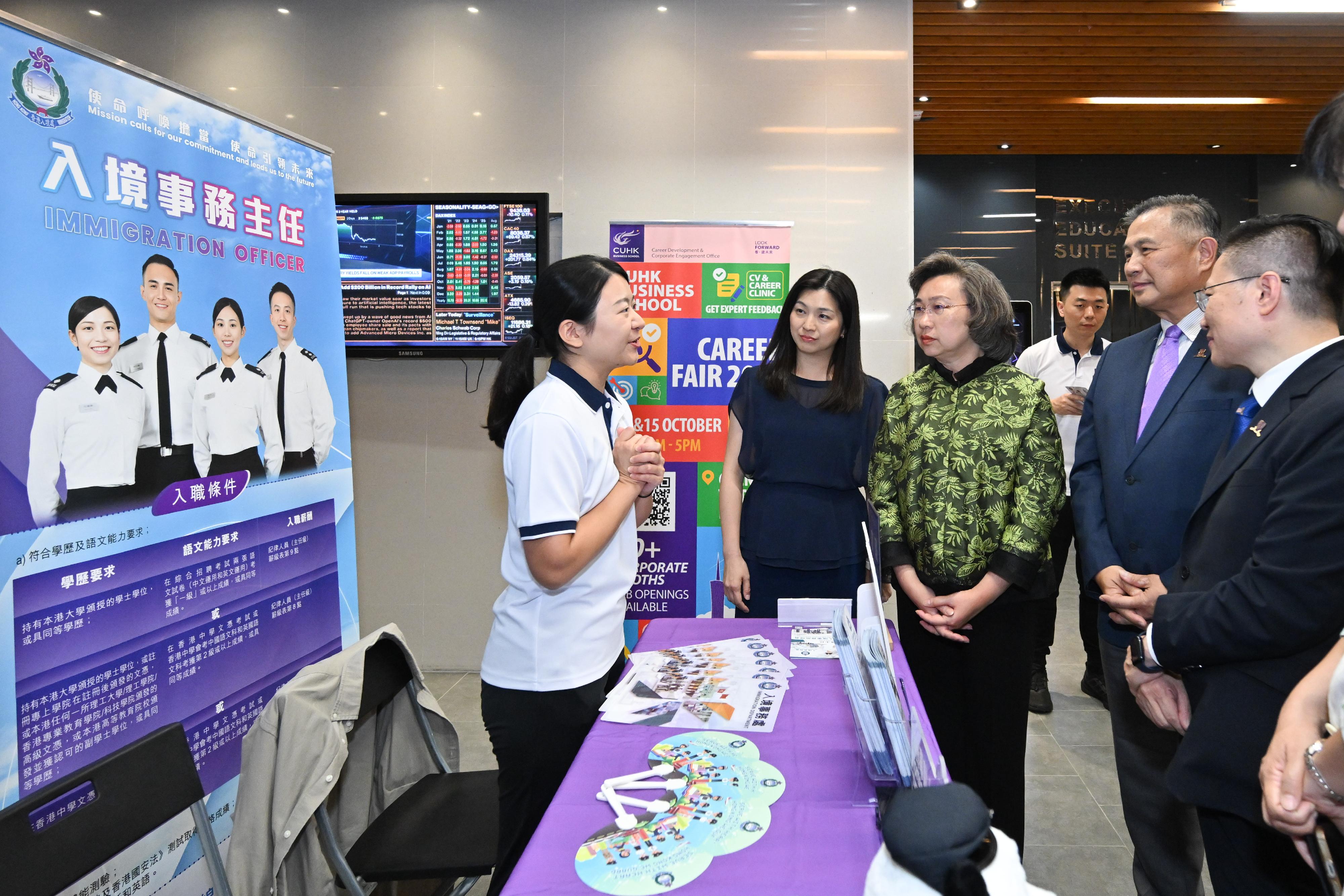 The Secretary for the Civil Service, Mrs Ingrid Yeung, visited the Government Career Fair at the campus of the Chinese University of Hong Kong (CUHK) this afternoon (October 2). Photo shows Mrs Yeung (centre) chatting with an officer from the Immigration Department at the department's booth that provides information about the Immigration Officer grade. Looking on is the Pro-Vice-Chancellor/Vice-President (Education) of the CUHK, Professor Irwin King (second right).