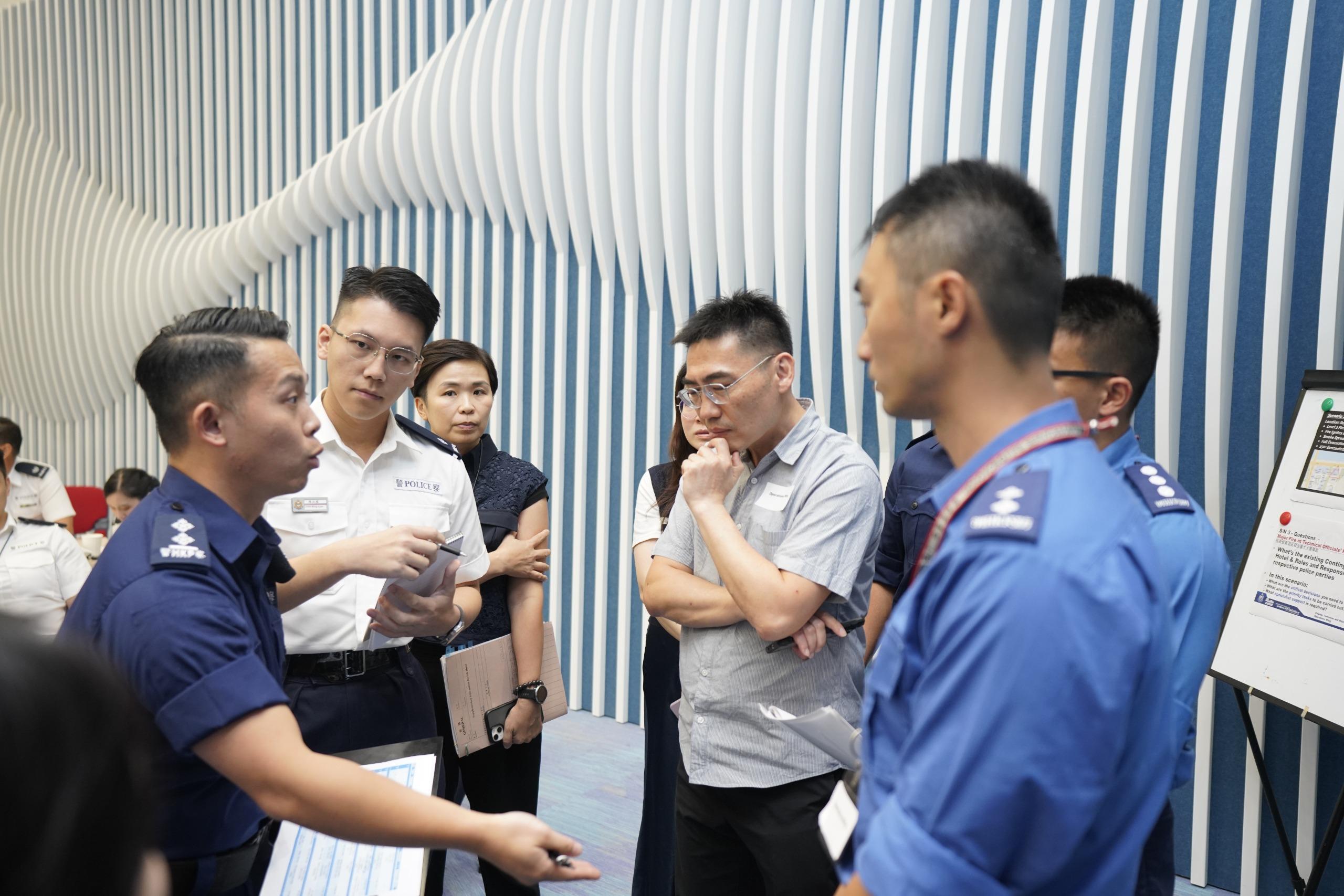 The Operations Wing of the Hong Kong Police Force today (October 3) conducted an inter-departmental tabletop exercise for the 15th National Games, the 12th National Games for Persons with Disabilities and the 9th National Special Olympic Games at the Police Headquarters. Photo shows representatives from disciplined services and relevant agencies discussing contingency response plans and coordination mechanisms for potential safety incidents during the events.
