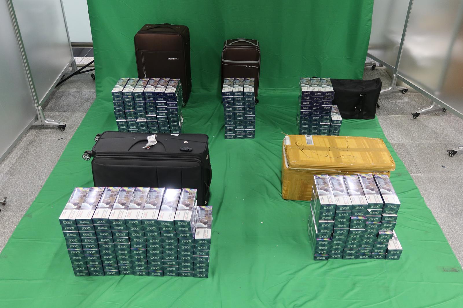 Two incoming male passengers were sentenced to three months' imprisonment with a fine of $1,000 and 14 weeks' imprisonment with a fine of $1,200 respectively by the West Kowloon Magistrates' Courts today (October 13) for possession of duty-not-paid cigarettes and failing to declare to Customs officers, in contravention of the Dutiable Commodities Ordinance.  Photo shows the duty-not-paid cigarettes seized.