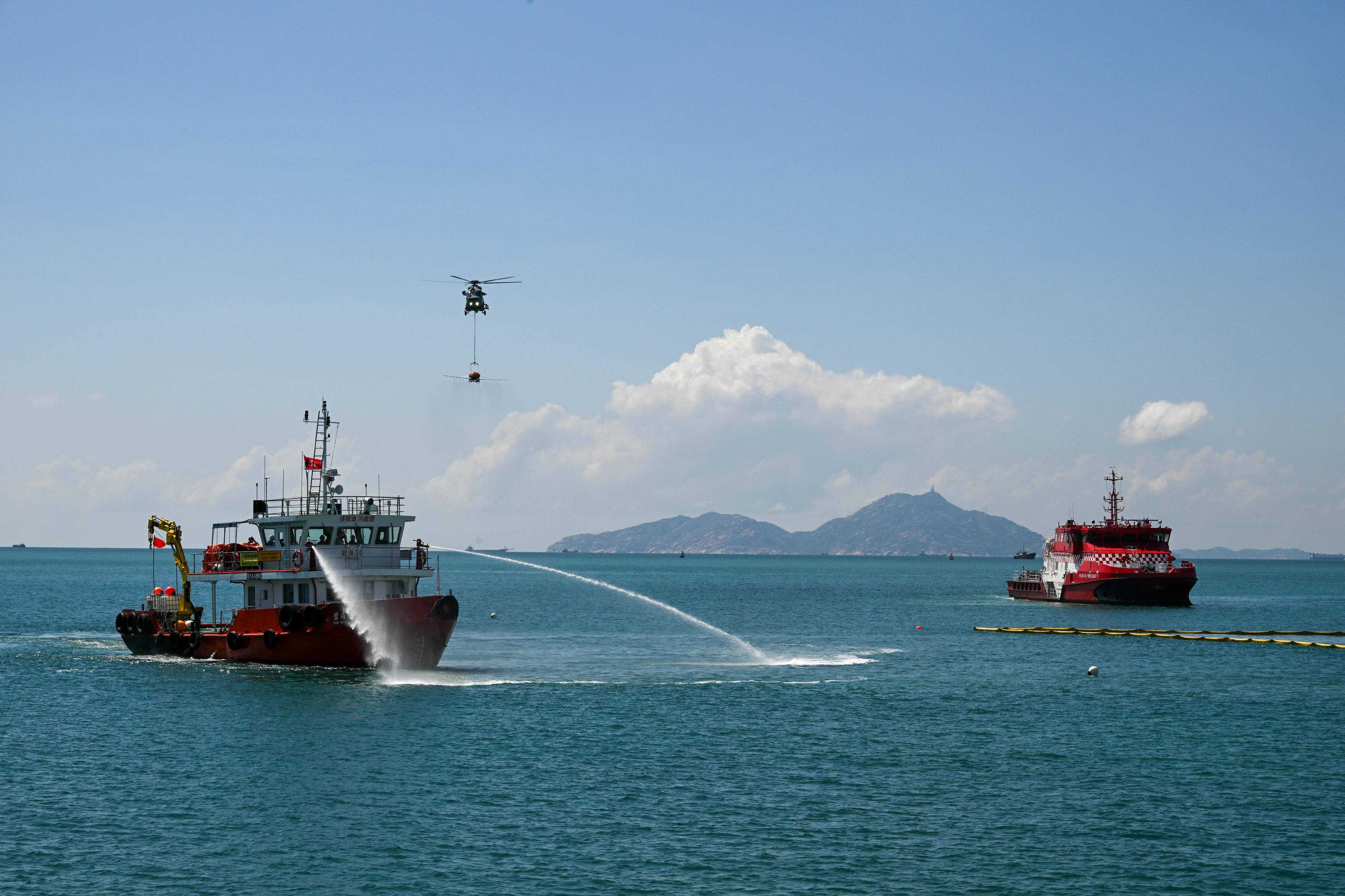 The annual marine pollution joint response exercises, codenamed "Oilex 2025" and "Maritime Hazardous and Noxious Substances (HNS) 2025", were conducted by various government departments this morning (October 15) at the waters off Ha Mei Wan of Lamma Island to test their marine pollution responses in the event of a spillage of oil and HNS in Hong Kong waters. Photo shows a pollution control vessel simulating the spraying of oil dispersant with water onto oil on the sea surface.