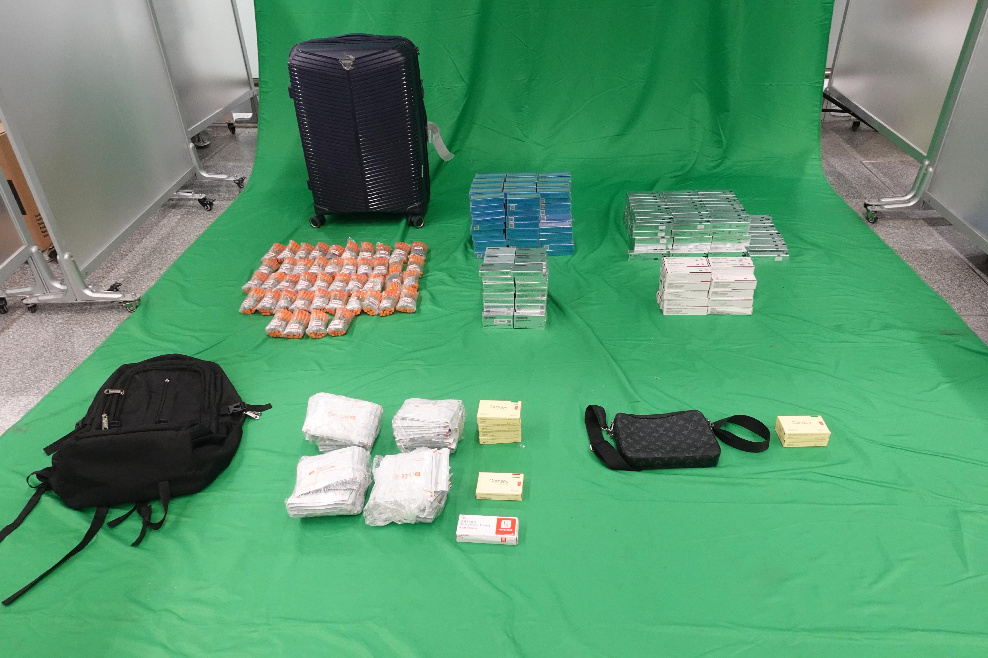 Hong Kong Customs on September 10 detected a smuggling case involving a passenger at Hong Kong International Airport and seized 1 100 pieces of pharmaceutical injections, 6 800 tablets of pharmaceutical products and 193 tubes of pharmaceutical ointment, all containing Part I Poisons. The total estimated market value was about $950,000. The passenger concerned was convicted and sentenced to four months' imprisonment by the West Kowloon Magistrates' Courts today (October 17) for contravening the Import and Export Ordinance (Cap. 60). All the pharmaceutical products were confiscated. Photo shows the pharmaceutical injections, pharmaceutical products and pharmaceutical ointment seized.