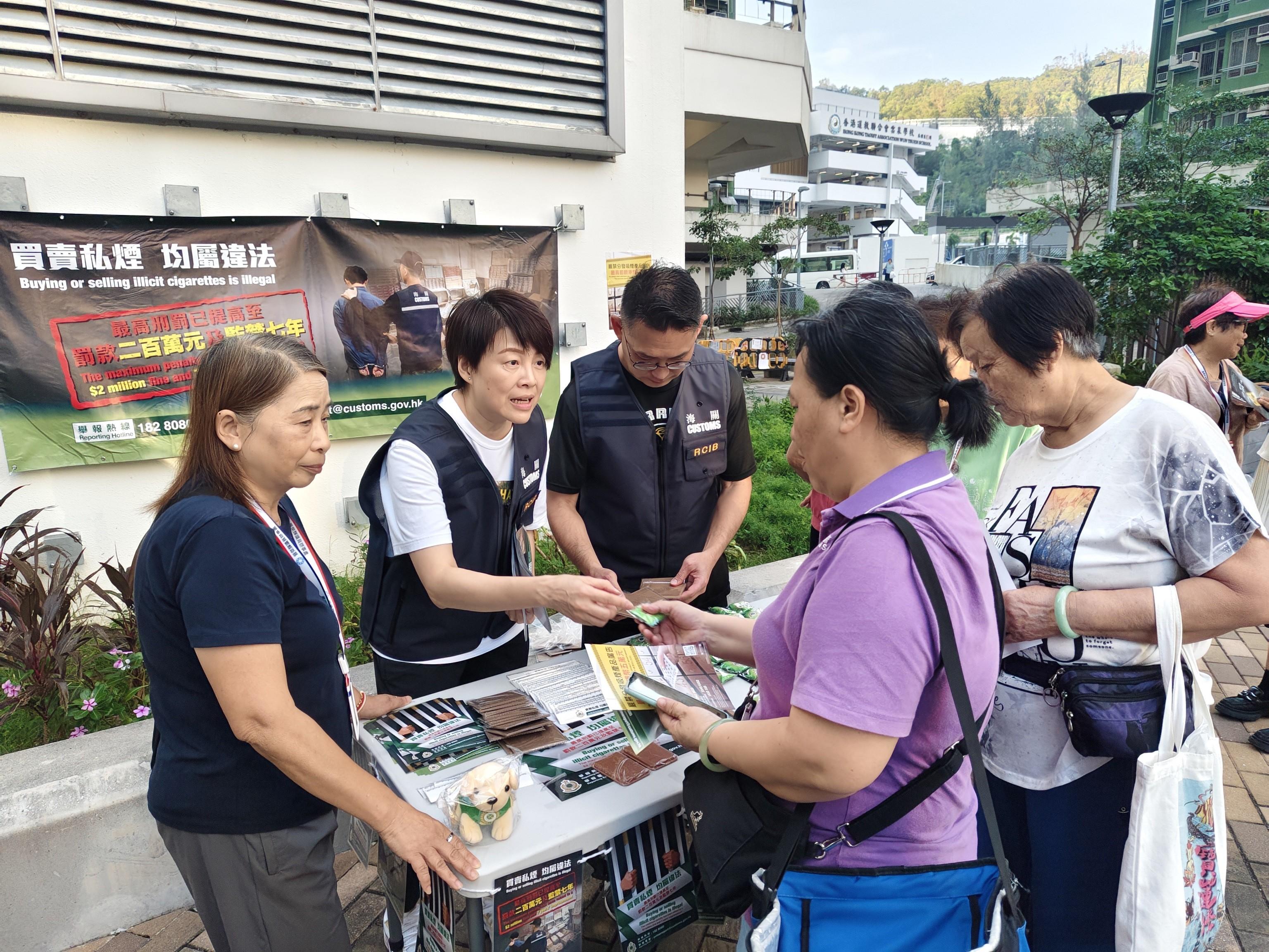 香港海關今日（十月十七日）與立法會議員顏汶羽、觀塘區區議員、衞生署控煙酒辦公室及房屋署在觀塘安泰邨進行聯合反私煙宣傳活動。圖示海關人員向居民推廣反私煙信息。