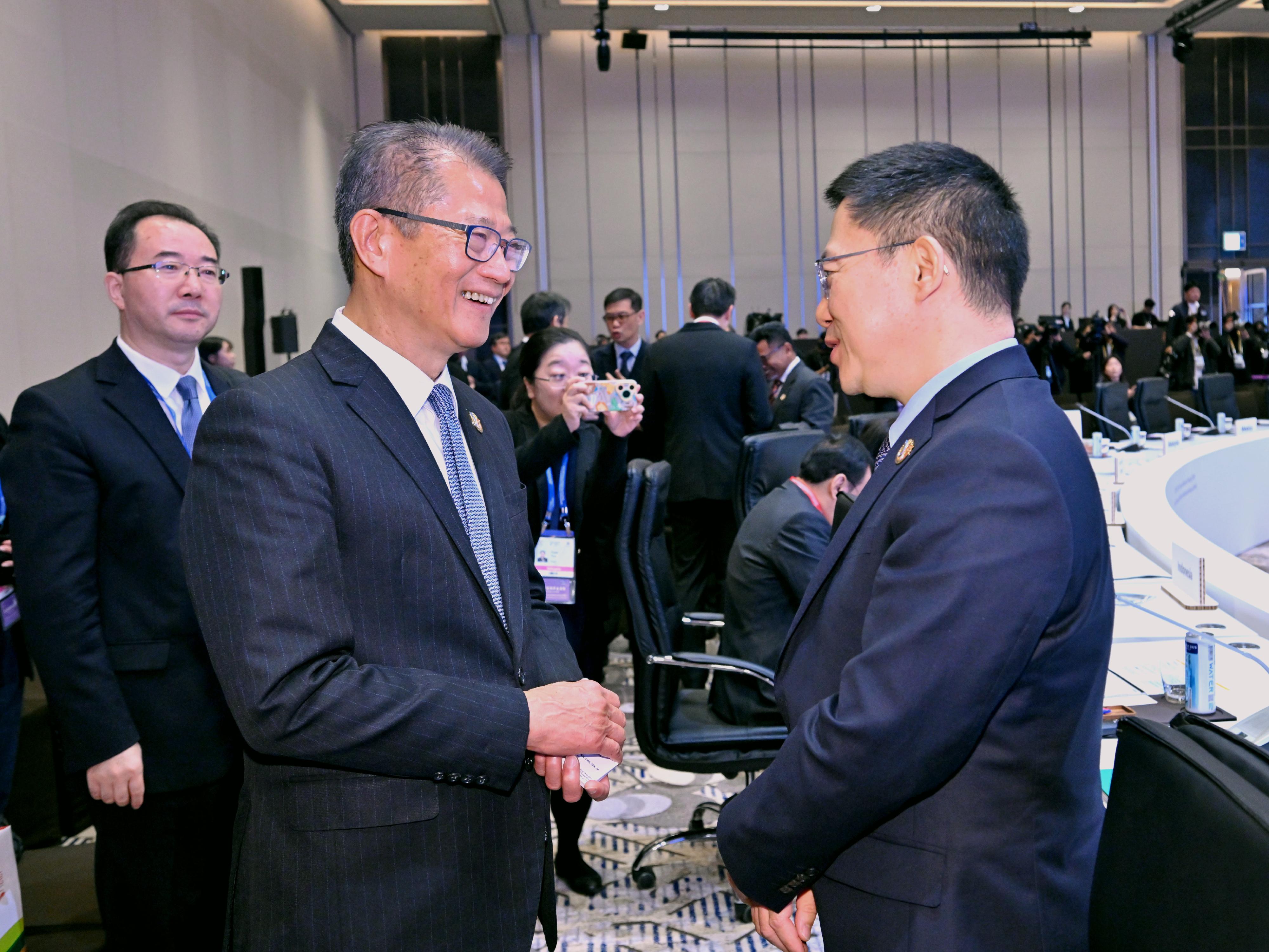 The Financial Secretary, Mr Paul Chan, attended the  Asia-Pacific Economic Cooperation Finance Ministers' Meeting in Incheon, Korea, today (October 21). Photo shows Mr Chan (second left) speaking with Vice Minister of Finance of the People's Republic of China Mr Liao Min (first right) at the meeting.