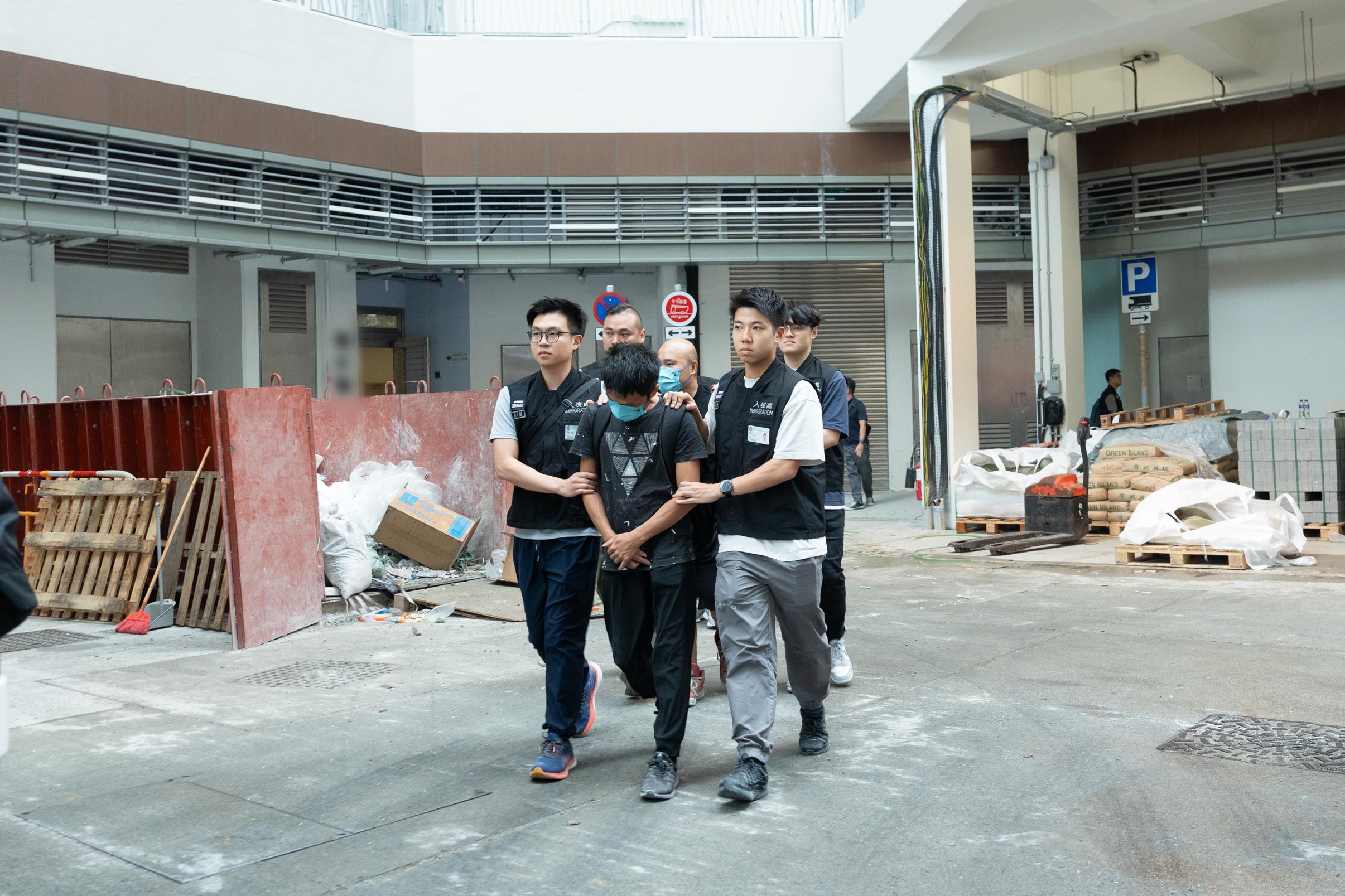 The Immigration Department mounted an anti-illegal worker operation codenamed "Contribute" for two consecutive days on October 20 and today (October 21) at Tung Chung District to combat the influx of illegal renovation workers. Photo shows suspected illegal workers arrested during the operation.