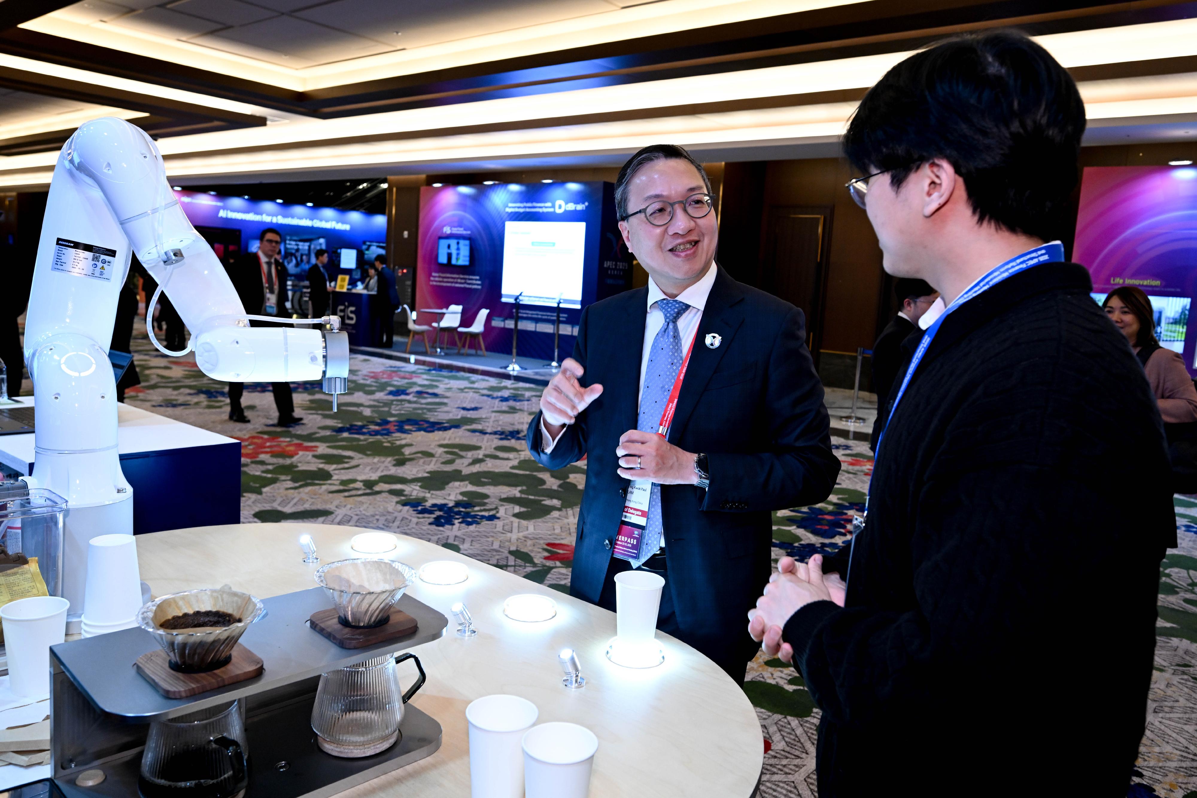 The Secretary for Justice, Mr Paul Lam, SC, attended the 2025 Asia-Pacific Economic Cooperation Structural Reform Ministerial Meeting in Incheon, Korea, today (October 22). Photo shows Mr Lam (left) touring the exhibition at the meeting venue.