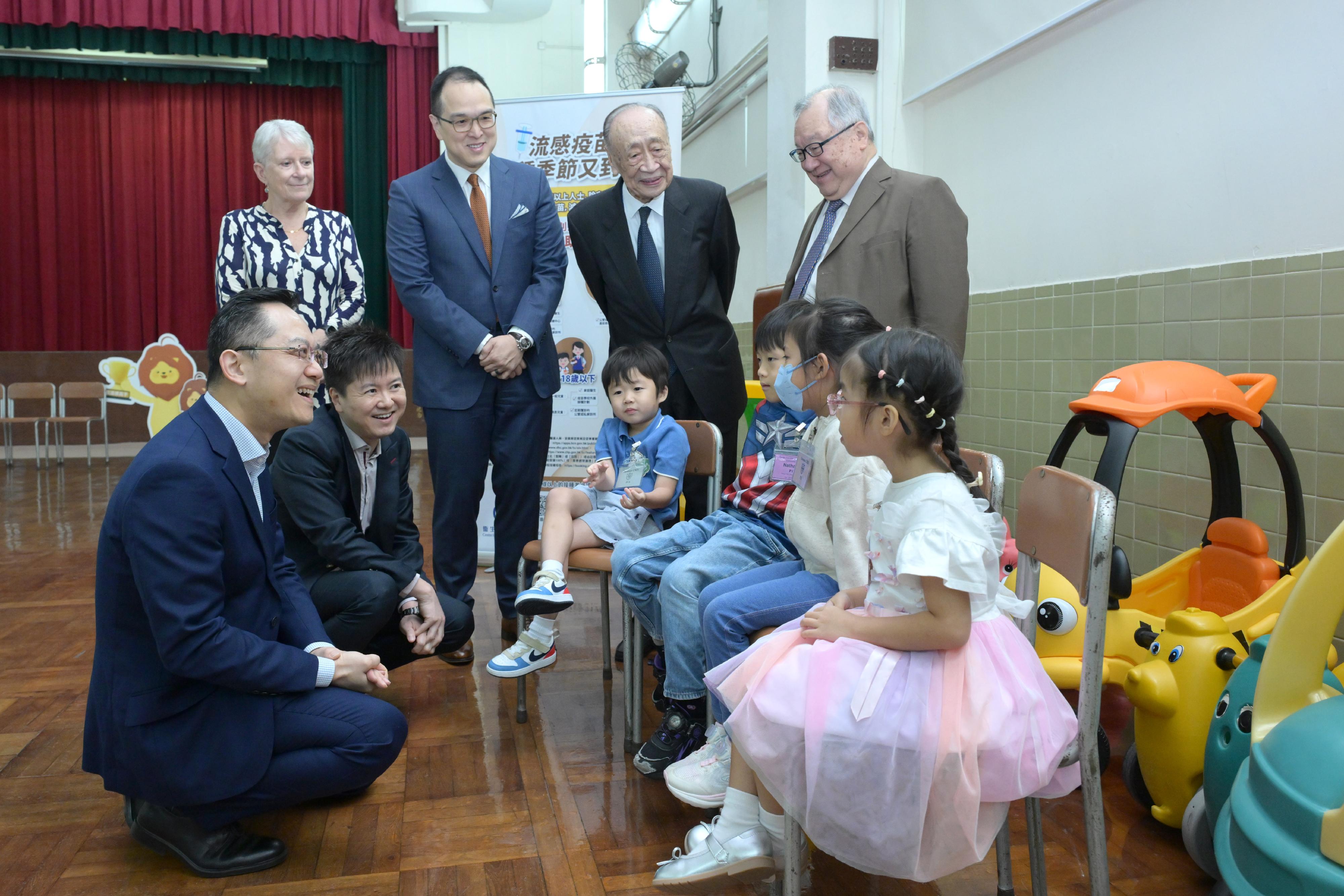 The Director of Health, Dr Ronald Lam, visited Kiangsu & Chekiang Primary School (International Section) in North Point this morning (October 28) to inspect the arrangements for the Seasonal Influenza Vaccination (SIV) School Outreach. He also urged schools to complete their vaccination activities as early as possible to provide convenience for parents. Working together to boost the vaccination rates can help reduce the risk of serious illness and death from seasonal influenza among children. Photo shows Dr Lam (front row, first left) and the Controller of the Centre for Health Protection, Dr Edwin Tsui　(front row, second left), chatting with students before they receive seasonal influenza vaccinations.