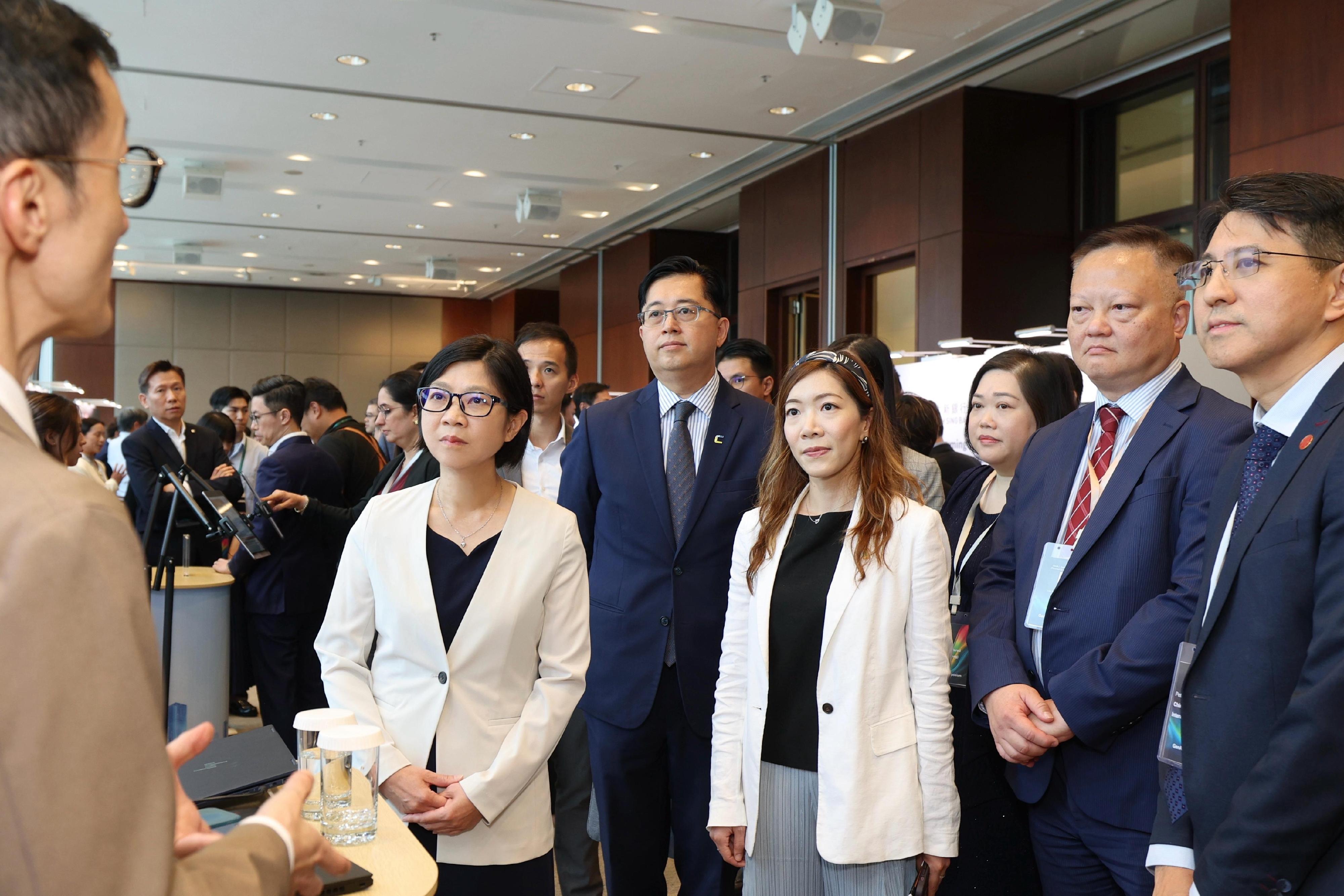 The Hong Kong Monetary Authority (HKMA), in collaboration with the Hong Kong Cyberport Management Company Limited (Cyberport), hosted the Generative Artificial Intelligence (GenA.I.) Symposium today (October 31). Through exhibition areas and expert sharing, the GenA.I. Symposium facilitates industry collaboration.  Photo shows the participating guests demonstrating innovative use cases developed in the GenA.I. Sandbox.