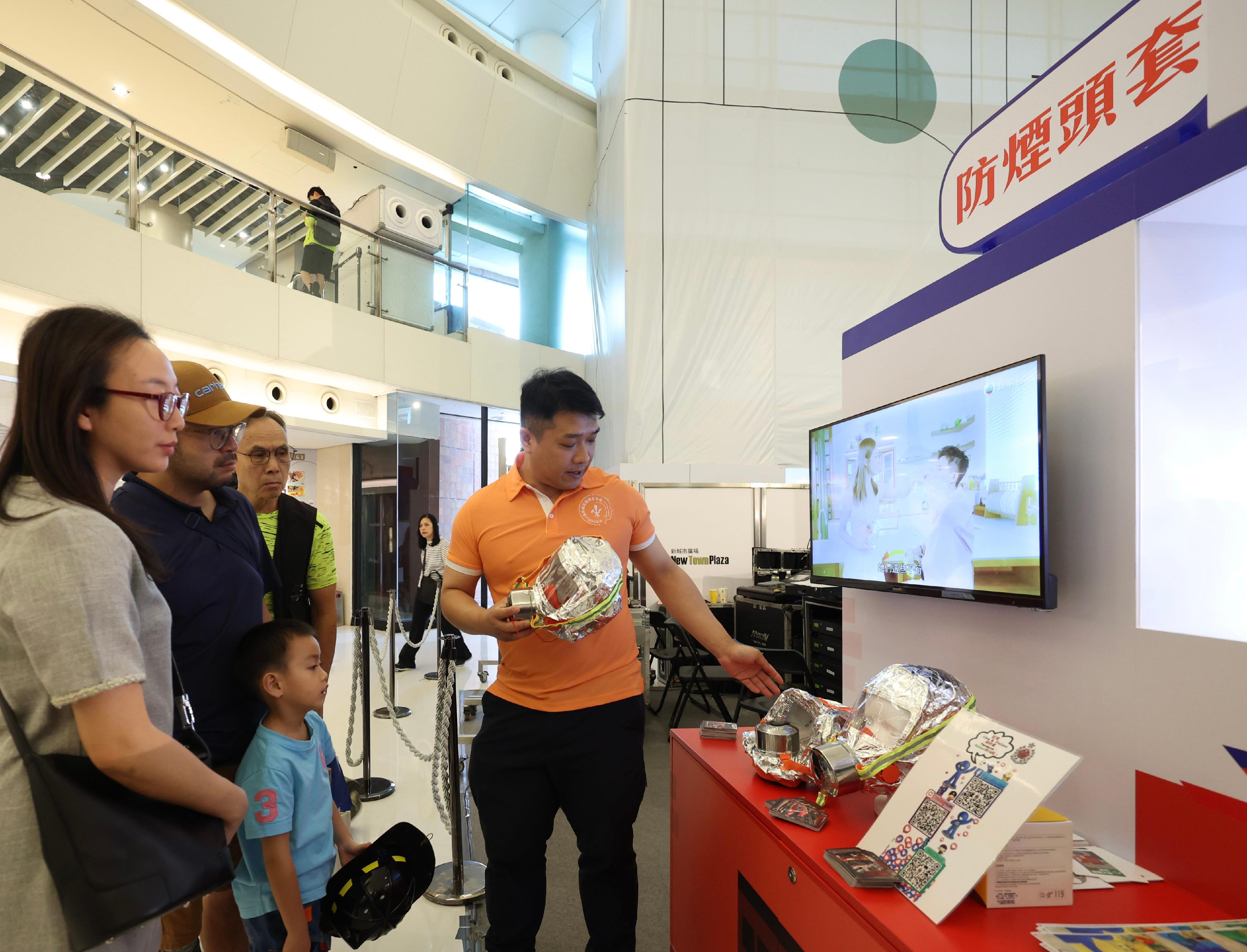 The Fire Services Department held the Winter Disaster and Emergency Preparedness Promotional Months launching ceremony and Fire Services Department Community Emergency Responder award ceremony at New Town Plaza in Sha Tin today (November 1). Photo shows members of the public learning to use fire escape hoods.