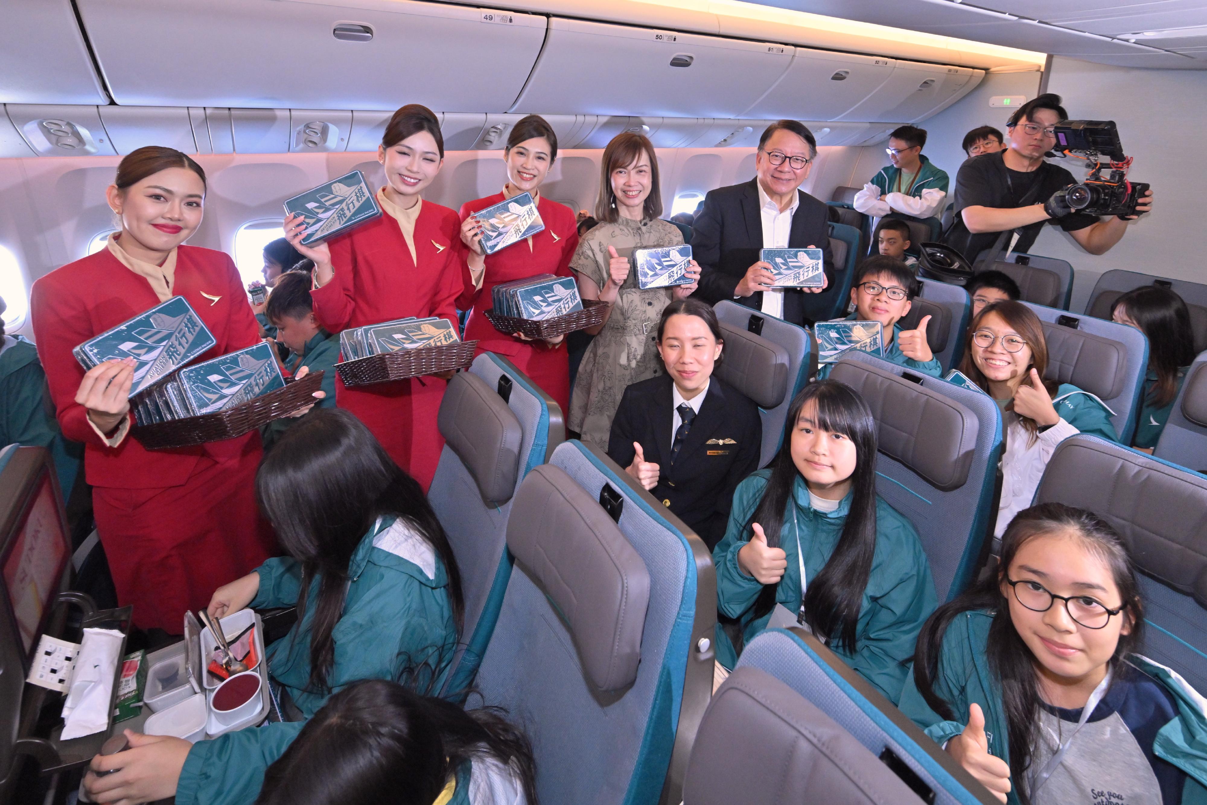 政務司司長陳國基今日（十一月一日）出席國泰飛躍理想計劃——空中之旅2025。圖示陳國基（右一）和國泰顧客及商務總裁劉凱詩（右二）與計劃的友師和學員合照。