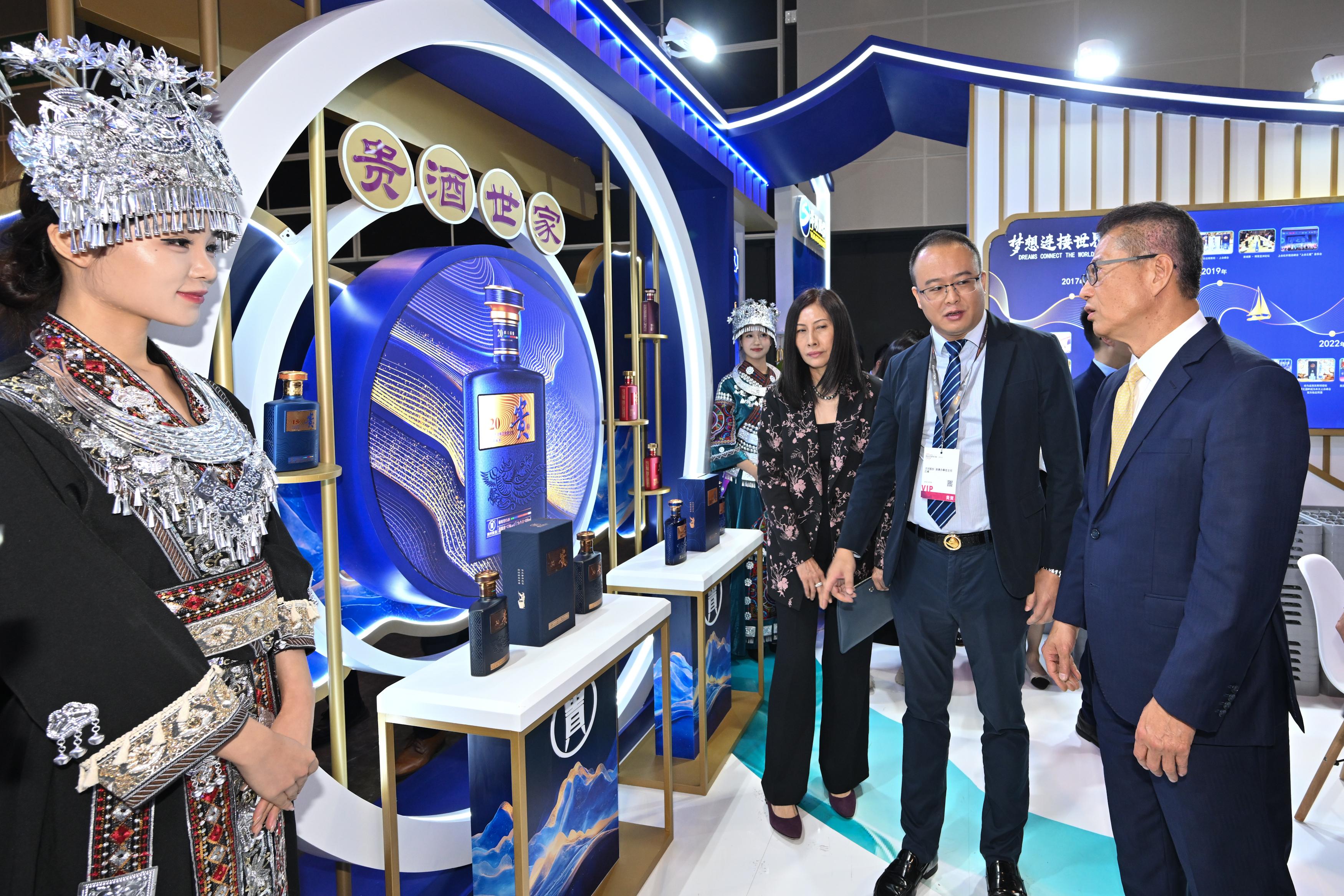 The Financial Secretary, Mr Paul Chan, attended the Hong Kong International Wine and Spirits Fair 2025 today (November 6). Photo shows Mr Chan (first right) visiting an exhibition booth. Looking on is the Acting Executive Director of the Hong Kong Trade Development Council, Ms Jenny Koo (third right).