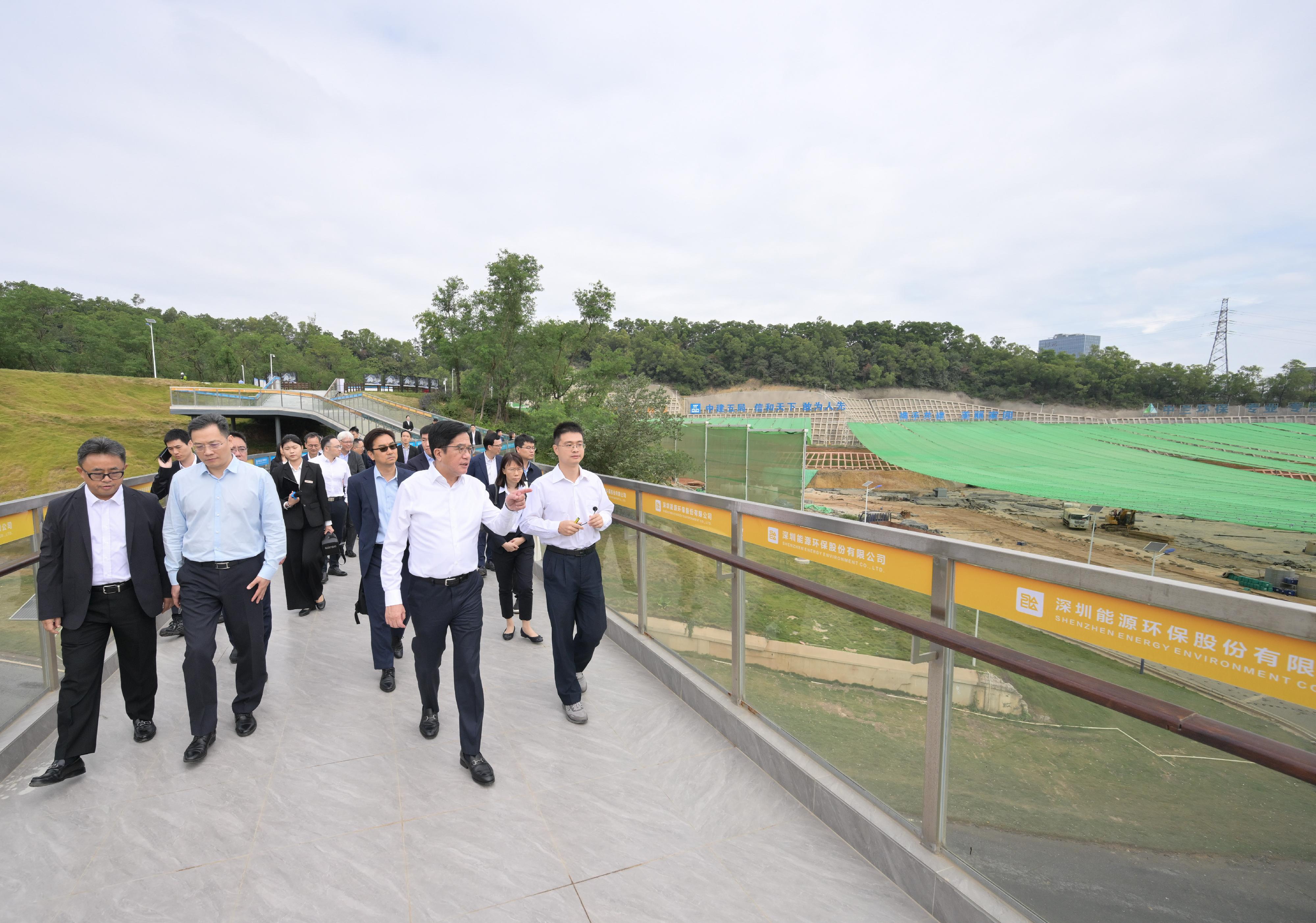 The Deputy Financial Secretary, Mr Michael Wong, and Vice Mayor of the Shenzhen Municipal People's Government Mr Tao Yongxin, leading delegations of the governments of the Hong Kong Special Administrative Region (HKSAR) and Shenzhen respectively, held a meeting of the Task Force for Collaboration on the Northern Metropolis Development Strategy in Shenzhen today (November 12). Photo shows Mr Wong (second right) and the HKSAR delegation visiting the Yulong Landfill Remediation Project in Luohu District to learn more about Shenzhen's efforts and achievements in safeguarding people's livelihood and ecological governance.