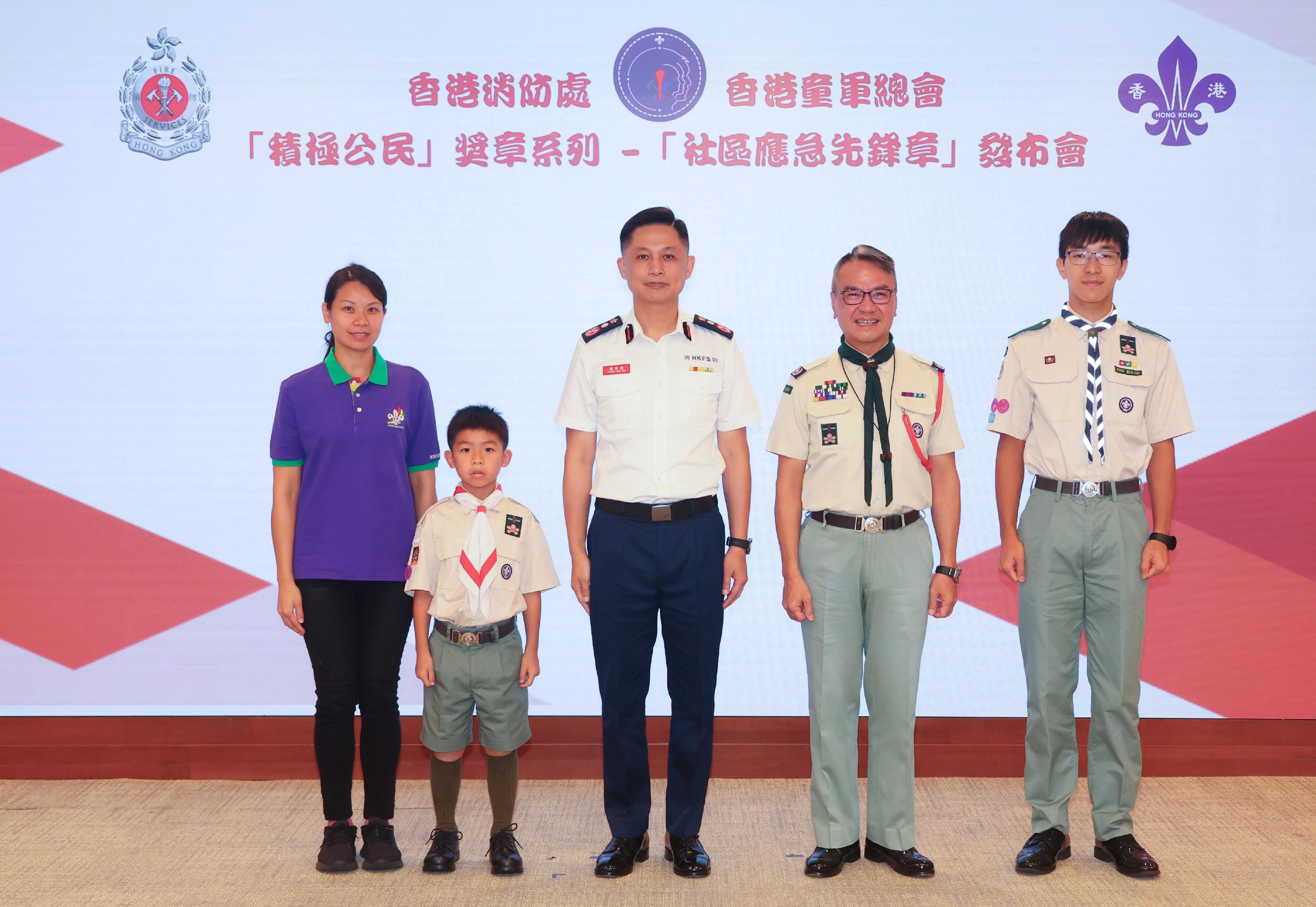 消防處與香港童軍總會今日(十一月十四日)宣布兩項最新合作安排,以推動童軍成員積極參與「消防處社區應急先鋒計劃」。圖示消防處處長楊恩健(中)、香港童軍總會香港總監黎偉生博士(右二)聯同香港童軍總會已參與成為「社區應急先鋒」的童軍成員合照。