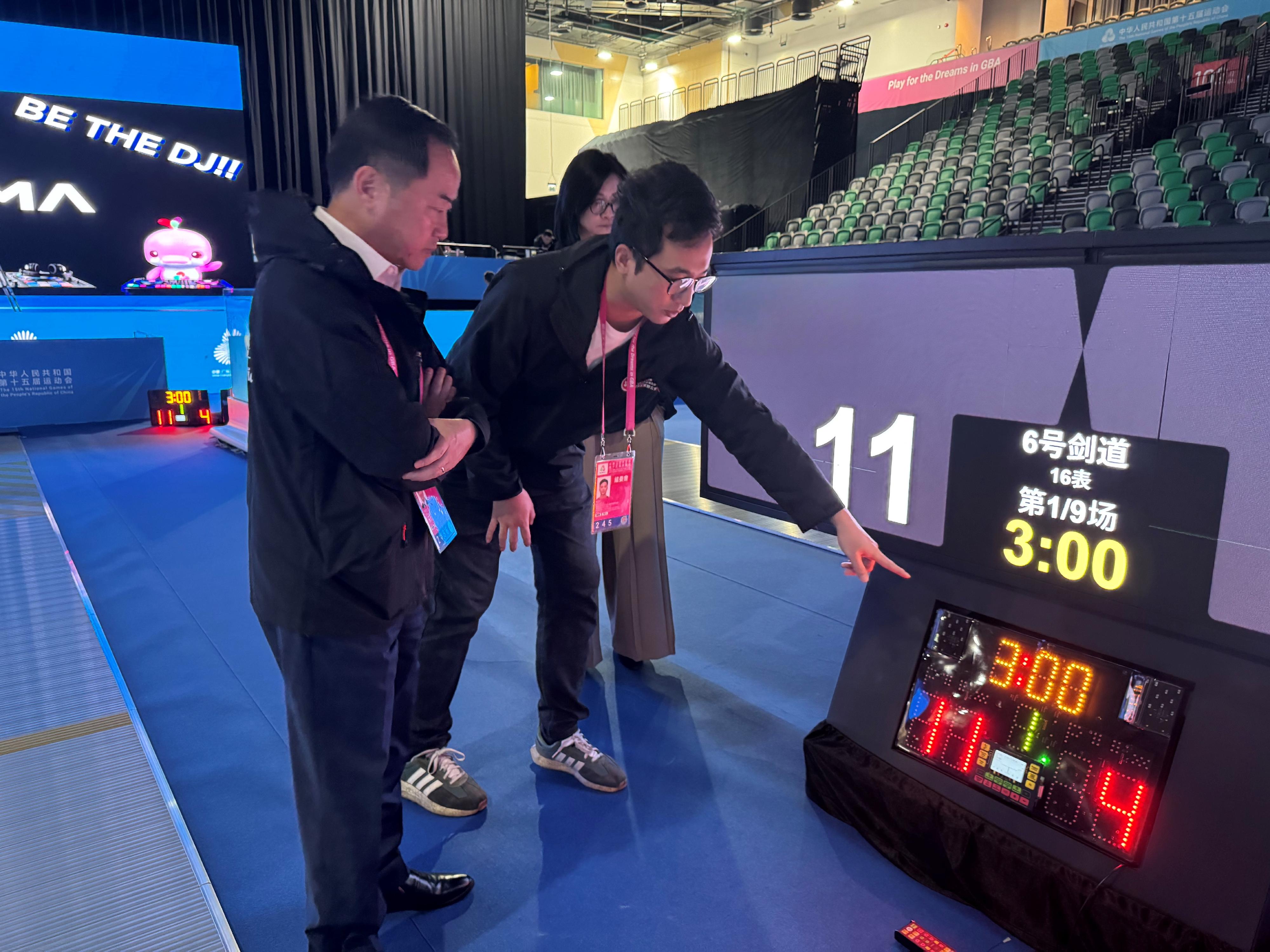 The Commissioner for Digital Policy, Mr Tony Wong (first left), inspected the operation status of the timing and scoring system at the Kai Tak Sports Park yesterday (November 13).