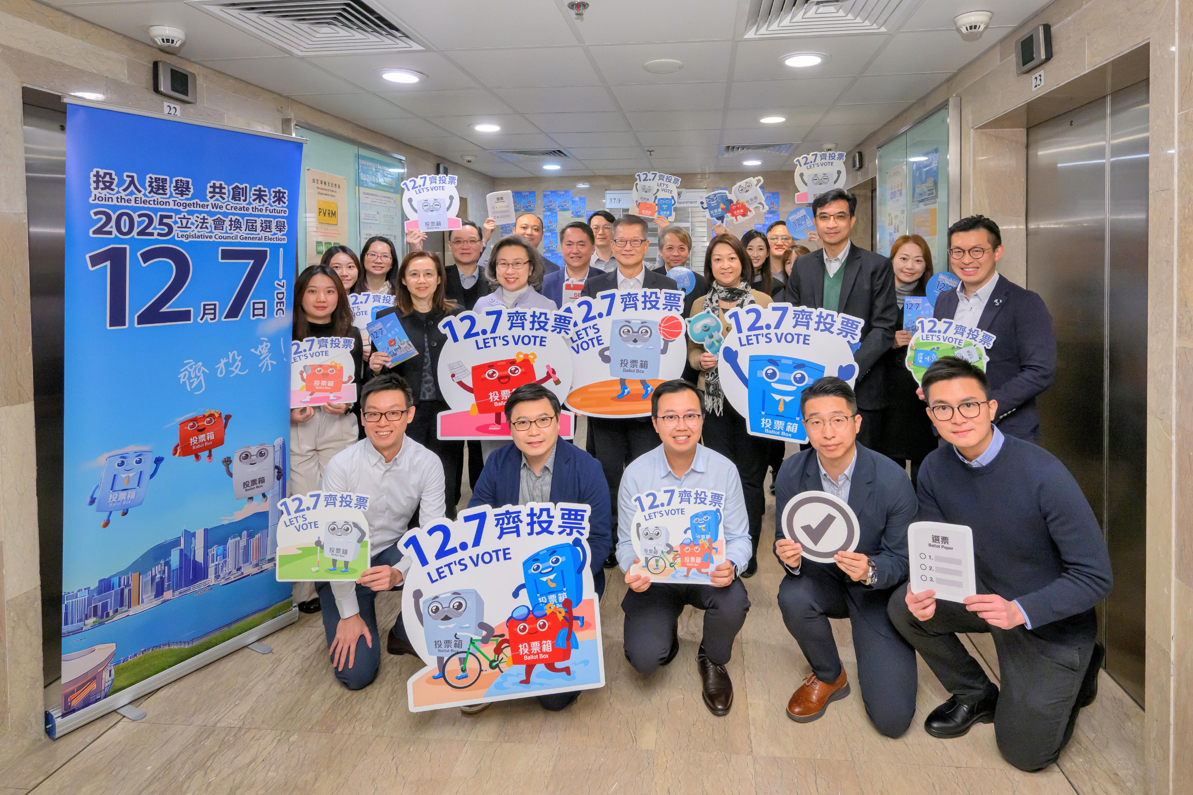 The Financial Secretary, Mr Paul Chan; the Secretary for Justice, Mr Paul Lam, SC; and the Secretary for the Civil Service, Mrs Ingrid Yeung, visited government offices in Wan Chai today (November 20) to promote and call on civil servants to vote together in the Legislative Council (LegCo) Election on December 7. Photo shows Mr Chan (second row, centre); Mrs Yeung (second row, third left); and the Commissioner for Transport, Ms Angela Lee (second row, third right), with colleagues of the Transport Department at its office.