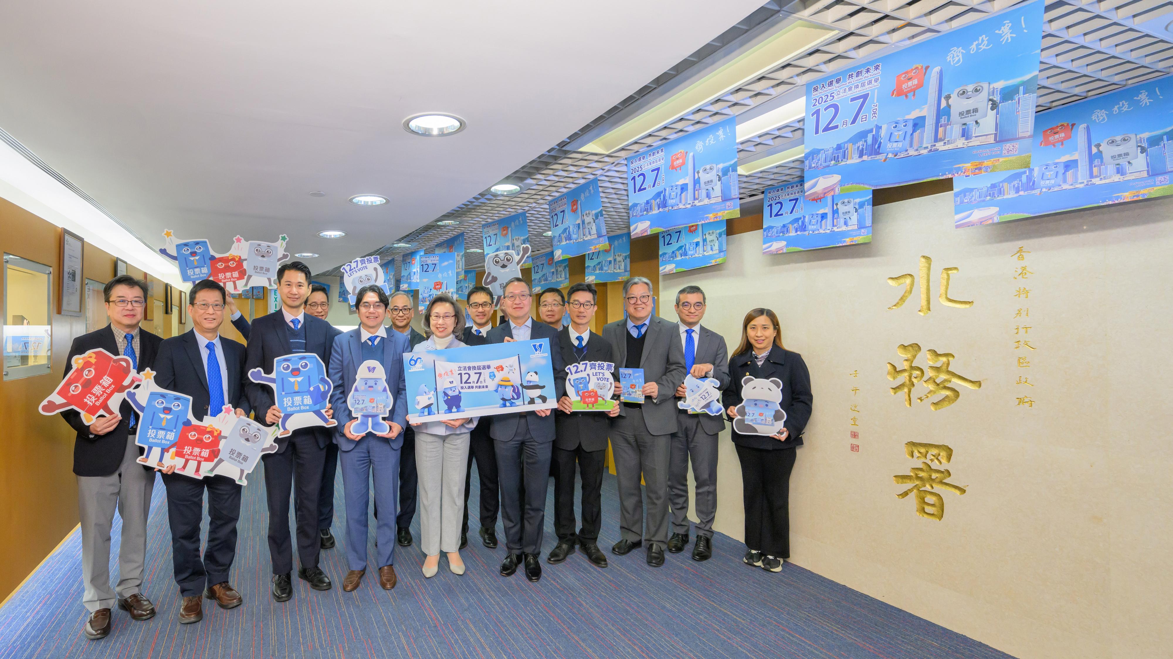 The Financial Secretary, Mr Paul Chan; the Secretary for Justice, Mr Paul Lam, SC; and the Secretary for the Civil Service, Mrs Ingrid Yeung, visited government offices in Wan Chai today (November 20) to promote and call on civil servants to vote together in the Legislative Council (LegCo) Election on December 7. Photo shows Mr Lam (front row, fifth right); Mrs Yeung (front row, fifth left); and the Director of Water Supplies, Mr Roger Wong (front row, fourth left), with colleagues of the Water Services Department (WSD) at the workplace of the WSD.