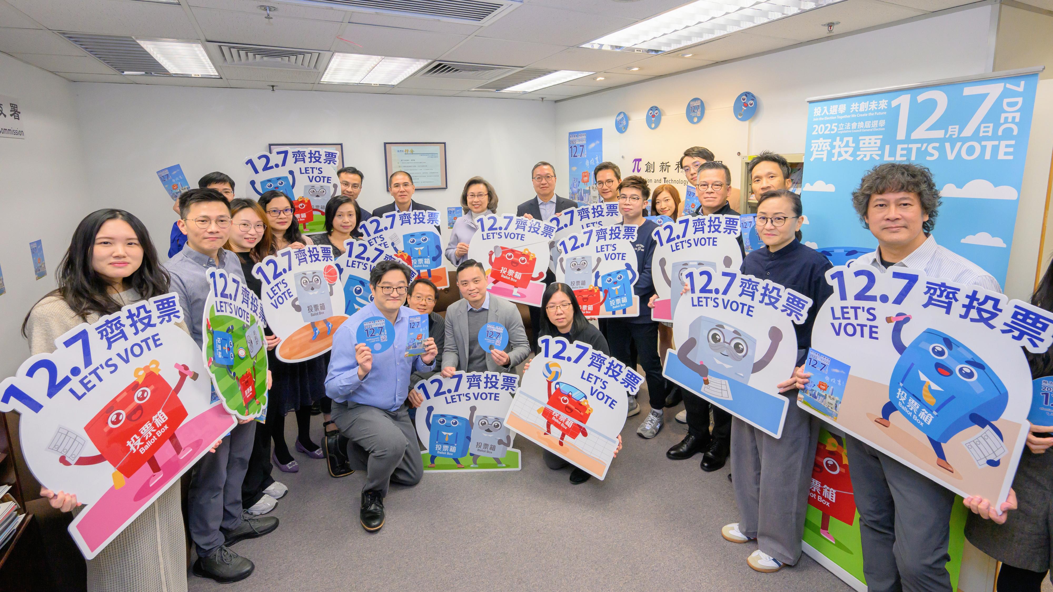 The Financial Secretary, Mr Paul Chan; the Secretary for Justice, Mr Paul Lam, SC; and the Secretary for the Civil Service, Mrs Ingrid Yeung, visited government offices in Wan Chai today (November 20) to promote and call on civil servants to vote together in the Legislative Council (LegCo) Election on December 7. Photo shows Mr Lam (standing, ninth right); Mrs Yeung (standing, 10th right); and the Assistant Commissioner for Innovation and Technology (Quality Services), Mr Lau Wai-ming (standing, eighth right), with colleagues of the Innovation and Technology Commission (ITC) at the workplace of the ITC.