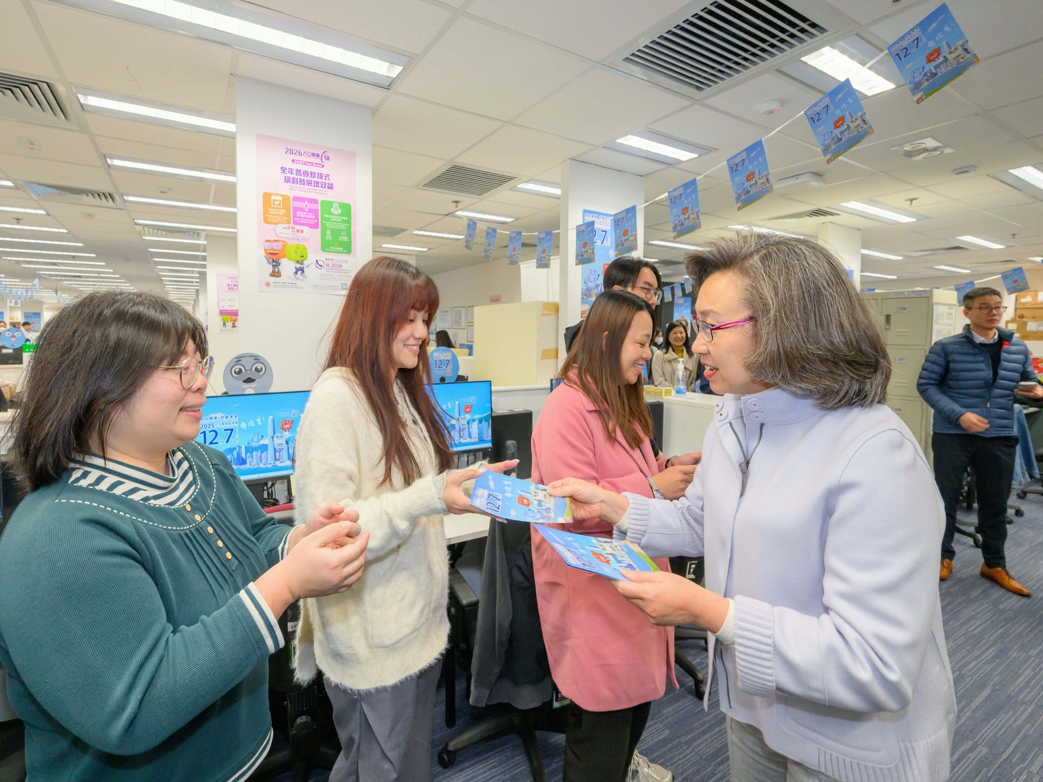 The Financial Secretary, Mr Paul Chan; the Secretary for Justice, Mr Paul Lam, SC; and the Secretary for the Civil Service, Mrs Ingrid Yeung, visited government offices in Wan Chai today (November 20) to promote and call on civil servants to vote together in the Legislative Council (LegCo) Election on December 7. Photo shows Mrs Yeung (first right) distributing leaflets to civil servants at the workplace of the Census and Statistics Department to remind them to vote with their families in the LegCo Election on December 7.