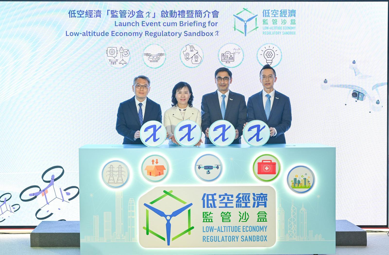 The launch event of the low-altitude economy "Regulatory Sandbox X" was held today (November 24). Photo shows the Secretary for Transport and Logistics, Ms Mable Chan (second left); the Director-General of Civil Aviation, Mr Victor Liu (first left); the Executive Director of Hong Kong Productivity Council (HKPC), Mr Mohamed Butt (second right), and the Chief Digital Officer of the HKPC, Mr Edmond Lai (first right), officiating at the ceremony.