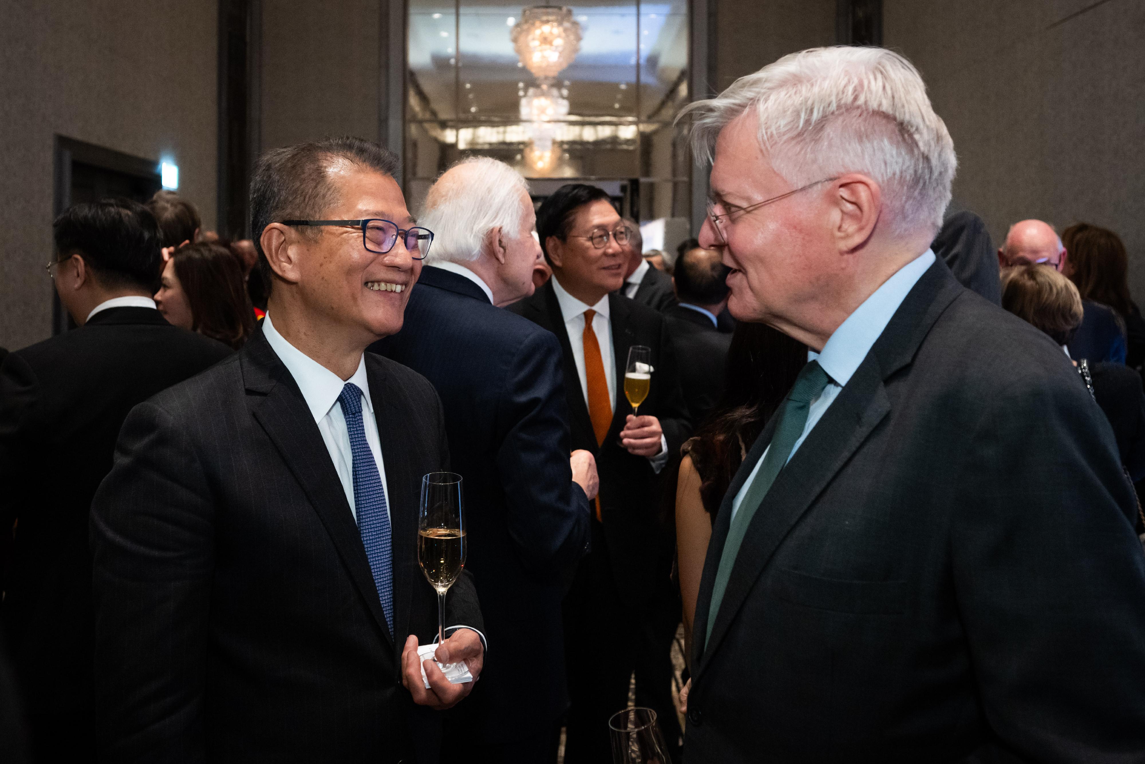 The Financial Secretary, Mr Paul Chan, arrived in London yesterday (November 25, London time) to begin his visit. Photo shows Mr Chan (left) engaging with other guests at the Hong Kong Dinner hosted by the Hong Kong Trade Development Council.